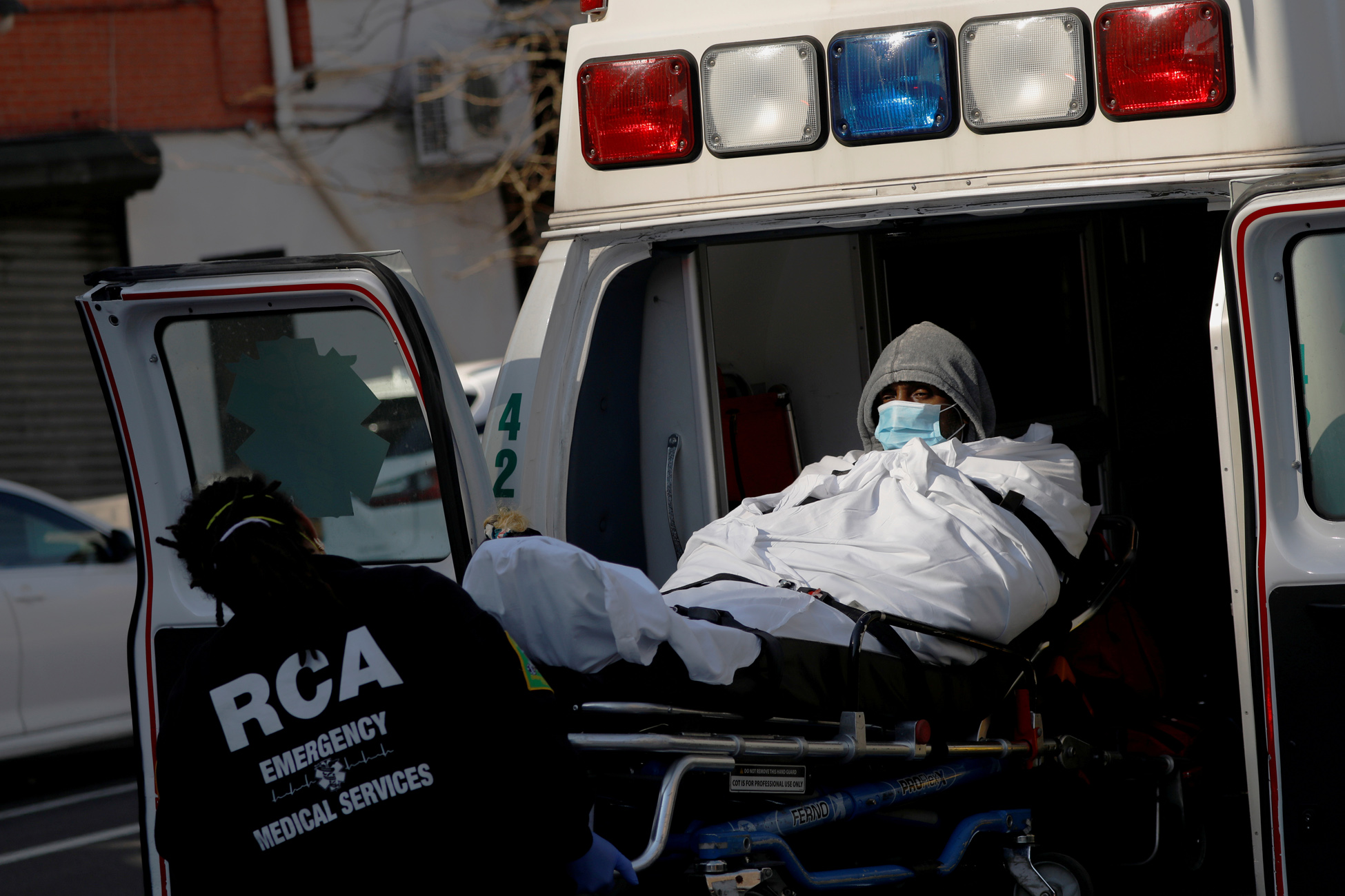 FILE PHOTO: E.M.T.'s load a patient into an ambulance as health workers continued to test people for coronavirus disease (COVID-19) outside the Brooklyn Hospital Center in Brooklyn, New York City, U.S., March 27, 2020. REUTERS