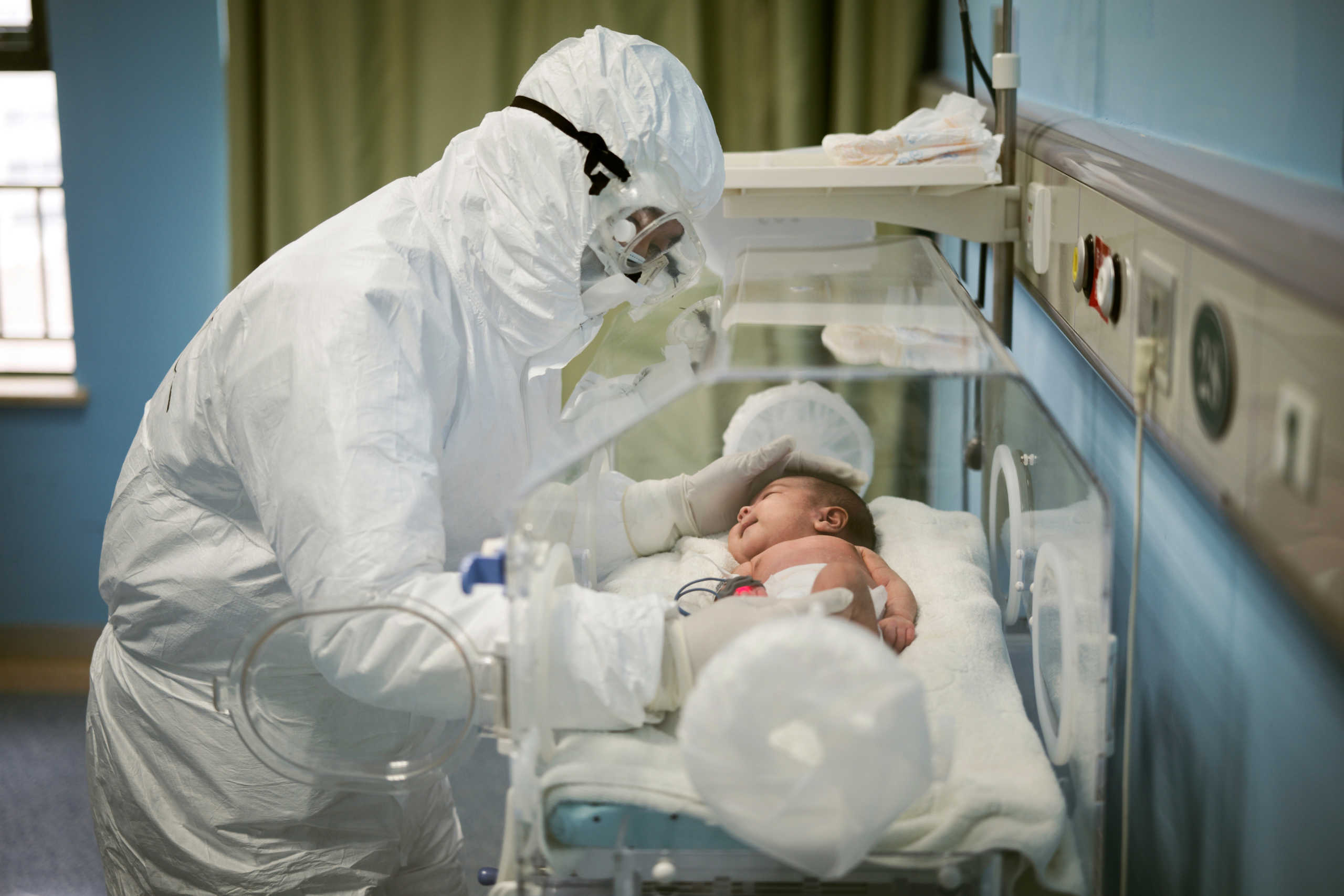 A medical staff attends to a baby with novel coronavirus at the Wuhan Children’s Hospital, in Wuhan, the epicentre of the novel coronavirus outbreak, in Hubei province, China March 6, 2020. Picture taken March 6, 2020. China Daily via REUTERS ATTENTION EDITORS - THIS IMAGE WAS PROVIDED BY A THIRD PARTY. CHINA OUT.