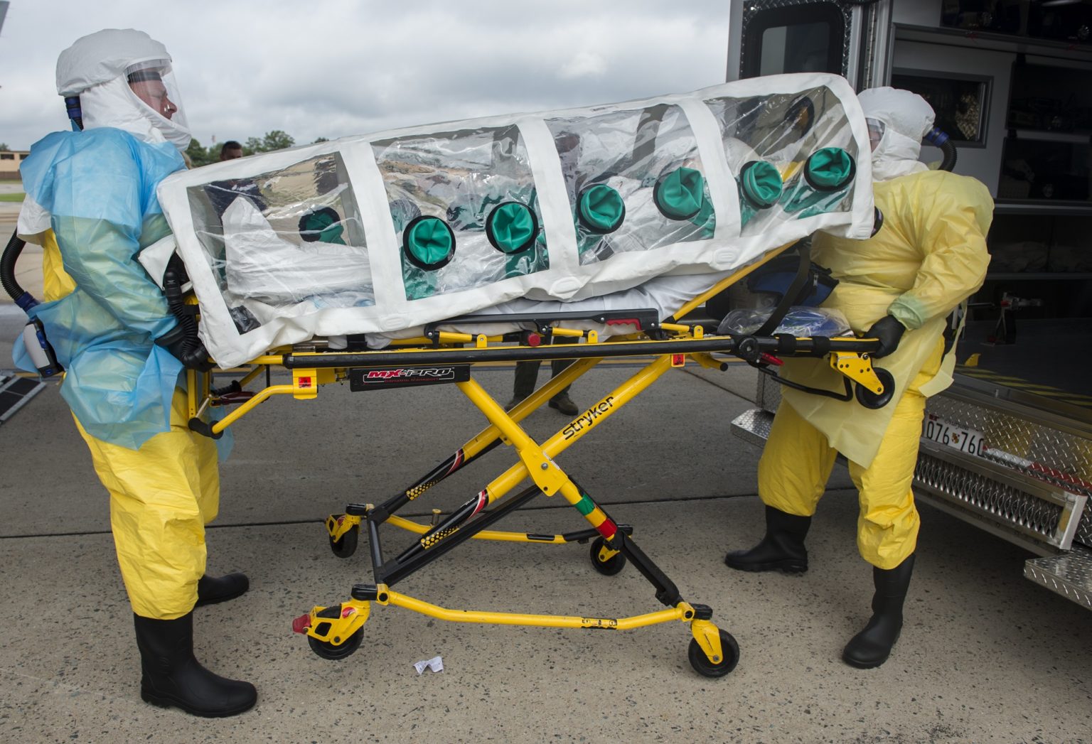 A simulated Ebola patient in an isolation pod is placed in an ambulance for transport to Walter Reed National Military Medical Center after arriving at Joint Base Andrews, Md. in support of Headquarters Air Mobility Command Exercise Mobility Solace Aug. 16, 2016. Exercise Mobility Solace provides AMC, working with joint partners, the opportunity to evaluate the protocols and operational sequences of moving multiple patients exposed or infected with Ebola using the Transport Isolation System while testing its capabilities and working in concert with various military units, first responders and local government agencies. (U.S. Air Force Photo by Tech. Sgt. Gregory Brook)