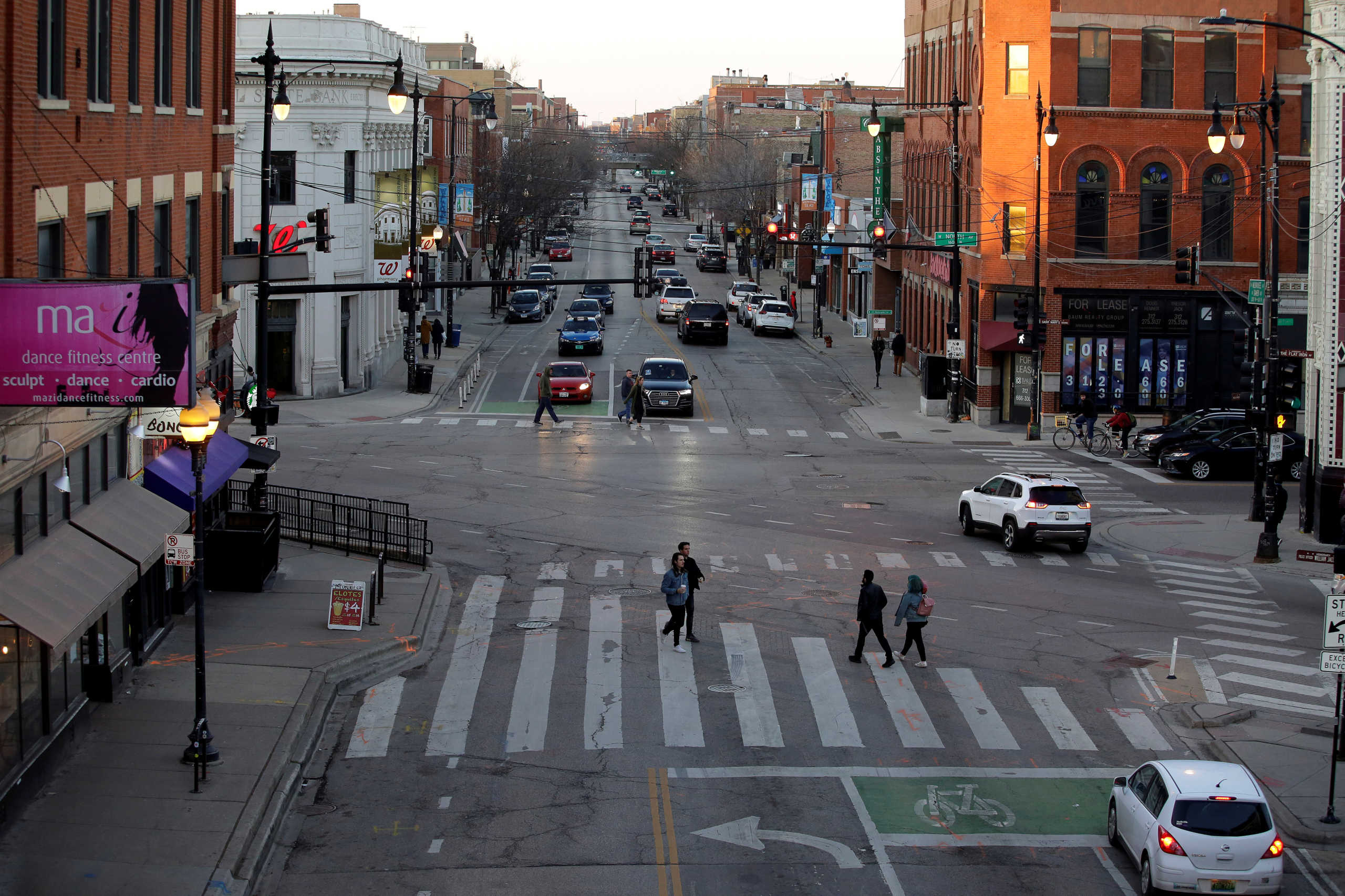 Motorists and pedestrians navigate through the Wicker Park neighborhood as Illinois Governor J.B. Pritzker ordered all restaurants and bars closed at the end of Monday's business day as part of efforts to combat the spread of novel coronavirus, in Chicago, Illinois, U.S. March 15, 2020.REUTERS