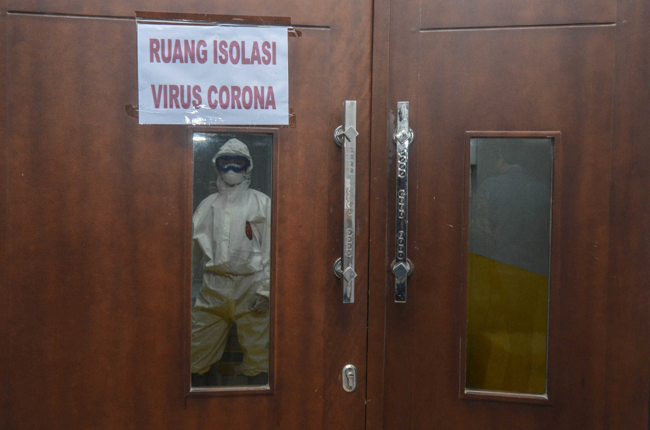 A medical officer looks on from an isolation room prepared for patients affected by the novel coronavirus disease of COVID-19 at a hospital in Garut, West Java province, Indonesia, March 3, 2020 in this photo taken by Antara Foto.  Antara Foto