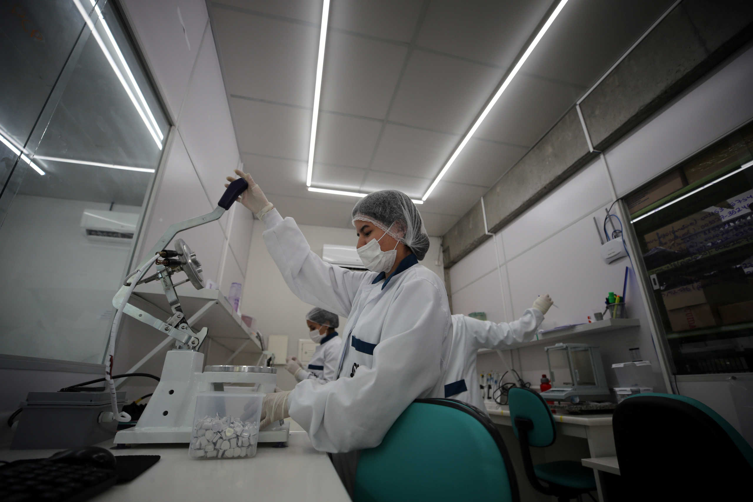 An employee of Brazilian health equipment startup Hi Technologies works in a batch of tests to diagnose the coronavirus disease (COVID-19), at their laboratory in Curitiba, Brazil, March 19, 2020. Picture taken March 19, 2020.  REUTERS
