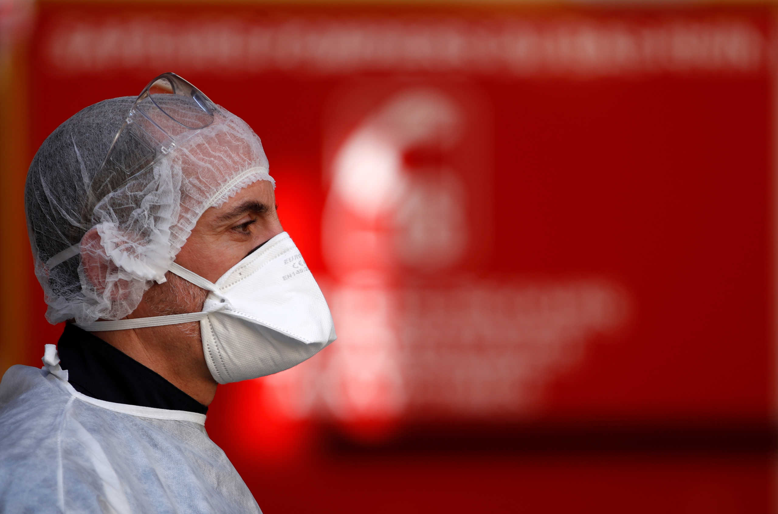 A member of a firefighters ambulance crew of the Departmental Fire and Rescue Service (SDIS 67) wears a face mask and protective suit during a rescue operation in Strasbourg as the spread of the coronavirus disease (COVID-19) continues in France, March 27, 2020. Picture taken March 27, 2020. REUTERS