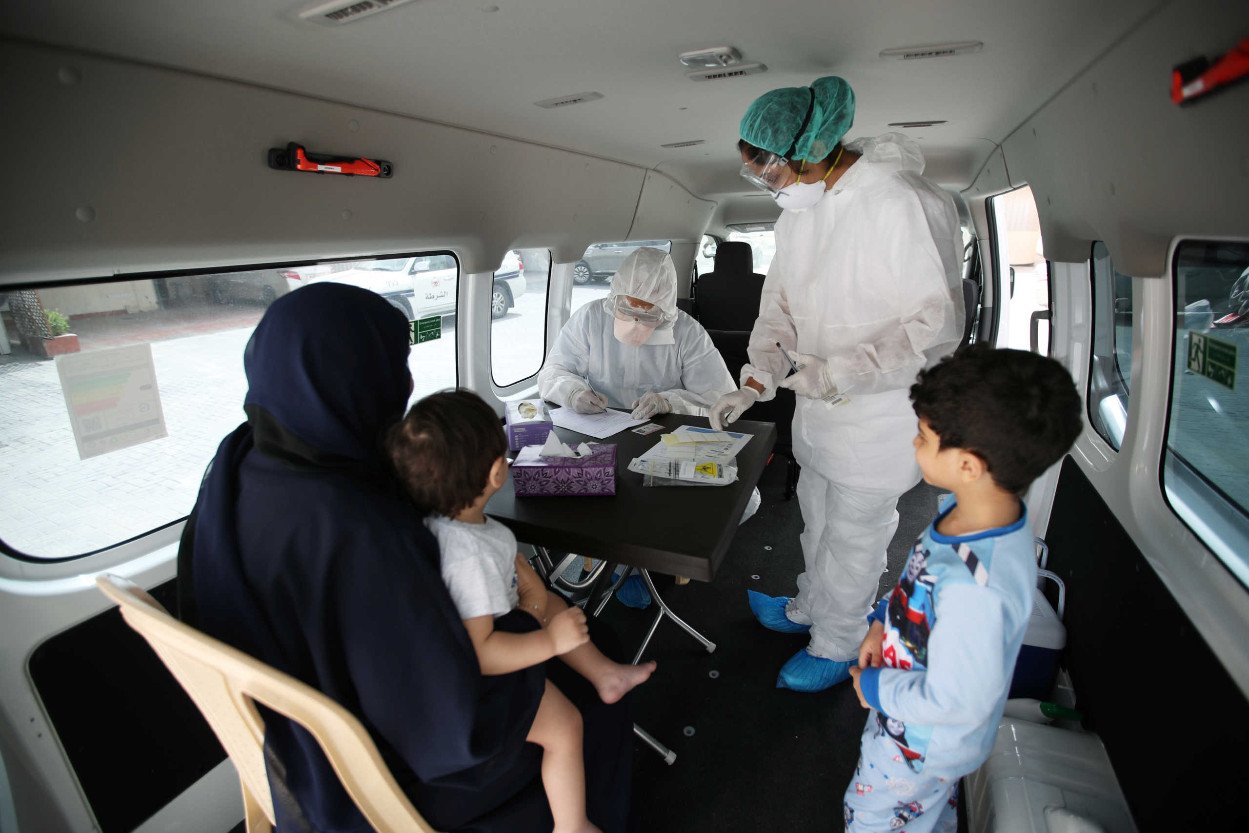 Doctors check a traveller in their designated residential area to check on residents who returned from Iran if anyone is infected with the novel coronavirus, at Isa Town Health Center, south of Manama, Bahrain, March 2, 2020. REUTERS