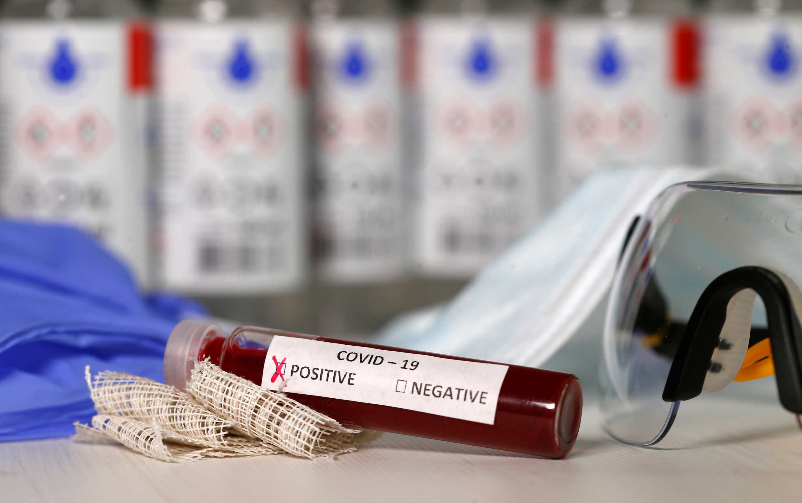 Fake blood is seen in test tubes labelled with the coronavirus (COVID-19) in this illustration taken March 17, 2020. REUTERS