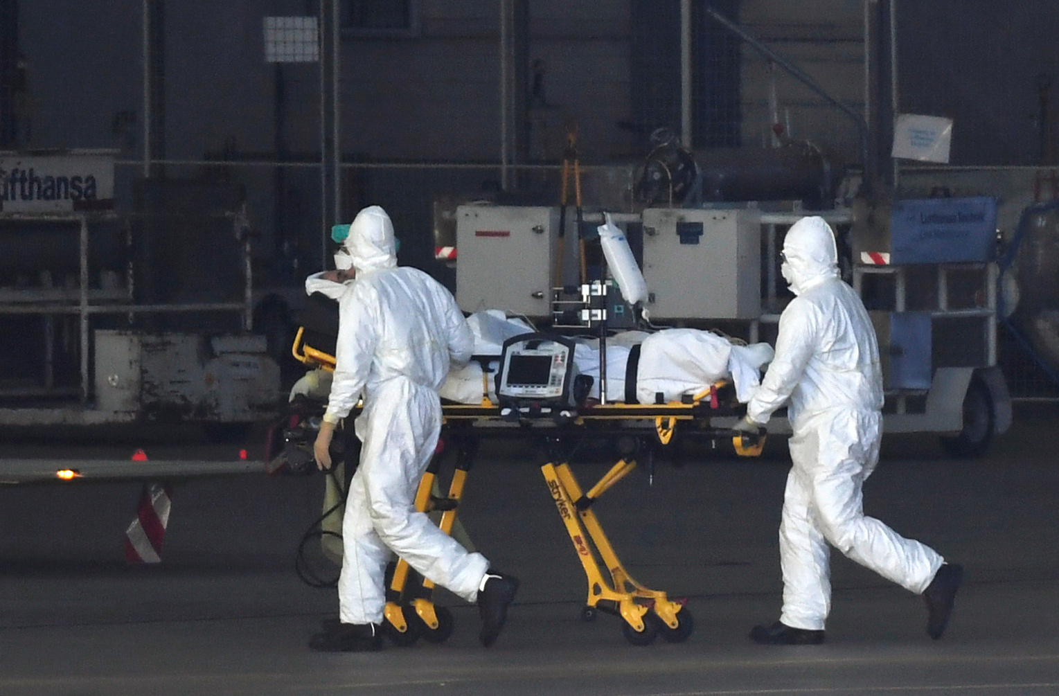 A patient from Bergamo is carried on a stretcher from a German Bundeswehr air force Airbus A-310 "Medivac" during their arrival at Helmut-Schmidt-Airport, as the spread of the coronavirus disease (COVID-19) continues, in Hamburg, Germany March 29, 2020. REUTERS