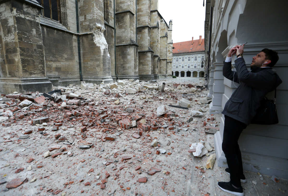 A man takes pictures of damages outside the cathedral of Zagreb after an earthquake, in Zagreb, Croatia March 22, 2020. REUTERS