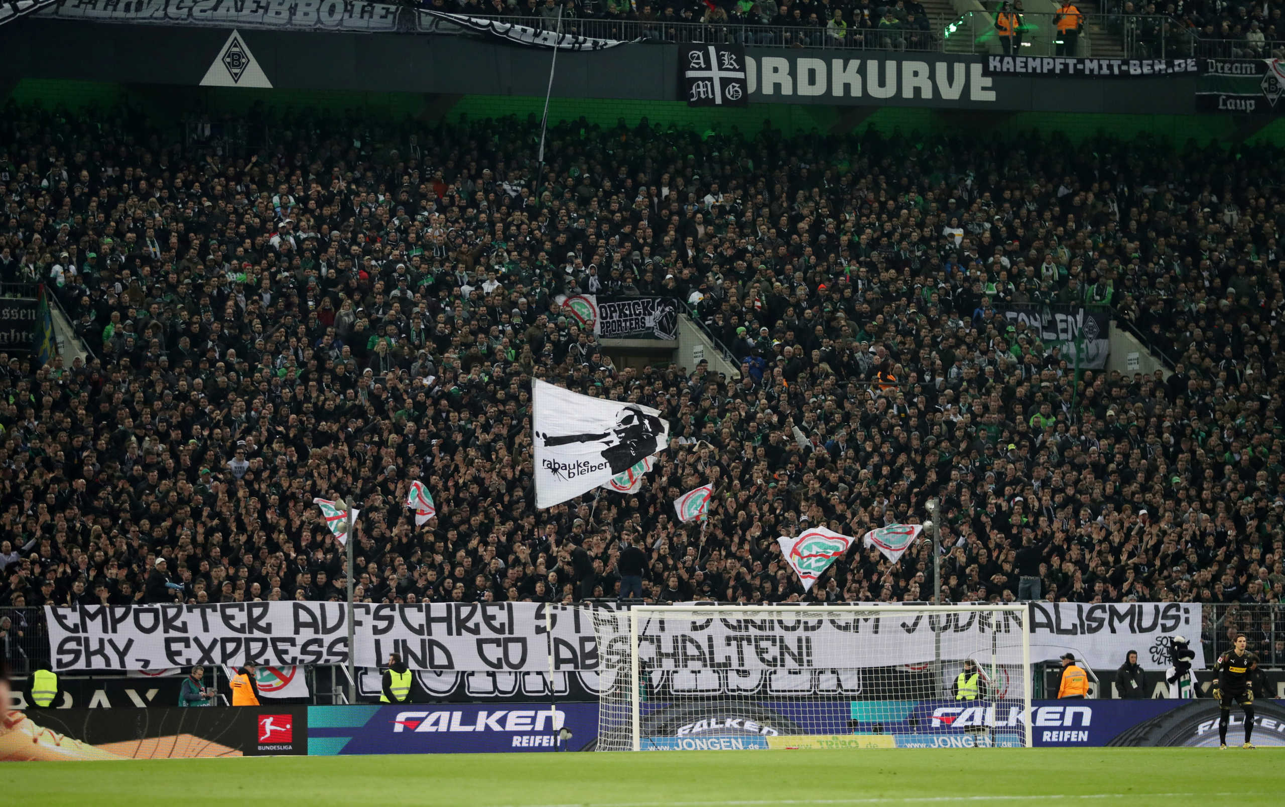 Soccer Football - Bundesliga - Borussia Moenchengladbach v Borussia Dortmund - Borussia-Park, Moenchengladbach, Germany - March 7, 2020  Fans inside the stadium hold up flags protesting against the German Football Association  REUTERS