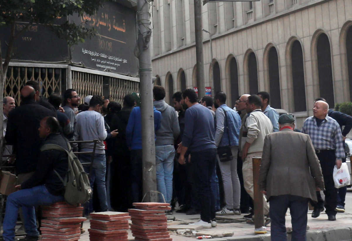 People gather in front of a branch of an Egyptian beauty shop "El Shabrawishi & Qesma" for perfume, cosmetics, and disinfectant following an outbreak of the coronavirus disease (COVID-19) in the Egyptian capital Cairo, Egypt March 18, 2020. REUTERS