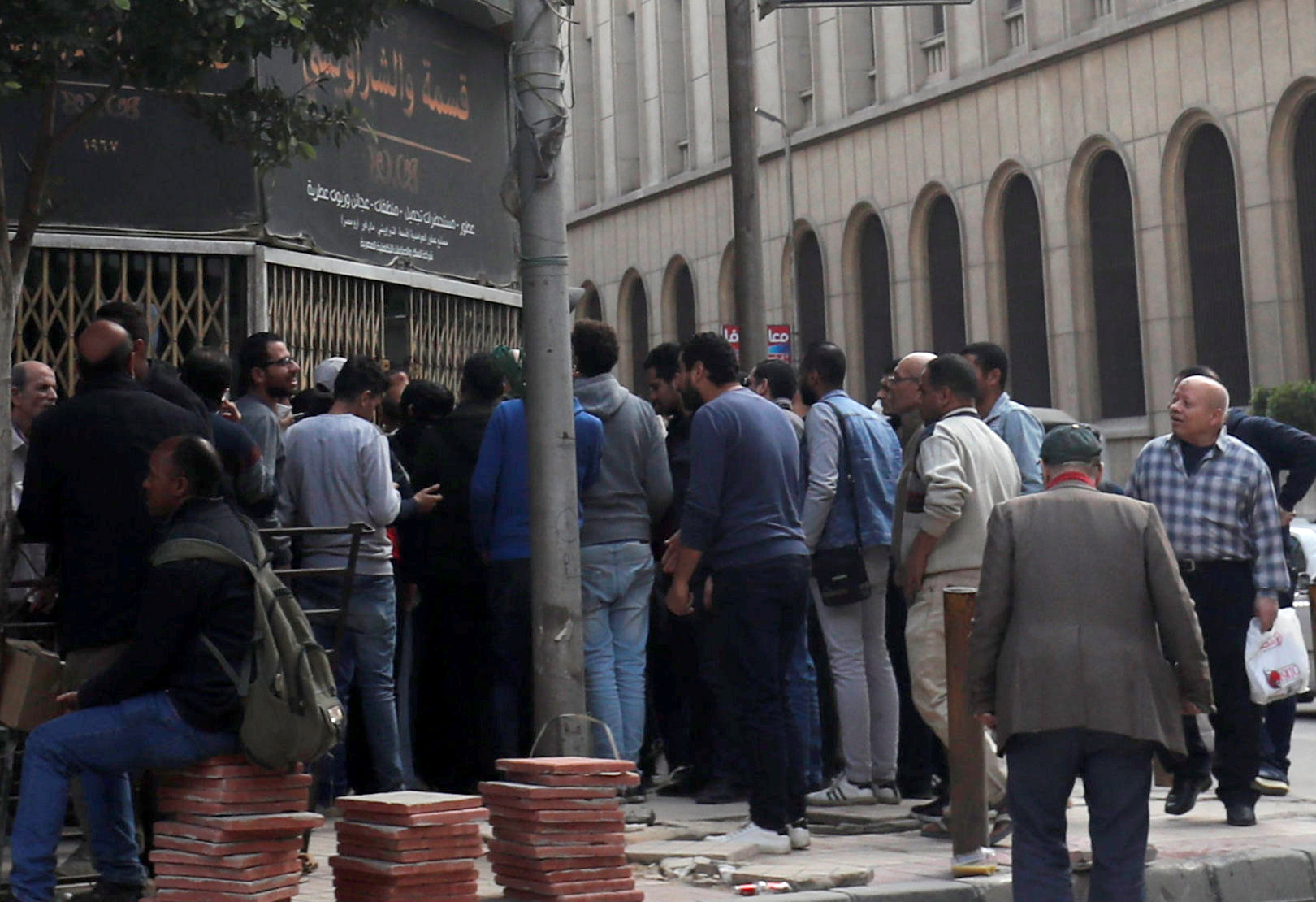 People gather in front of a branch of an Egyptian beauty shop "El Shabrawishi & Qesma" for perfume, cosmetics, and disinfectant following an outbreak of the coronavirus disease (COVID-19) in the Egyptian capital Cairo, Egypt March 18, 2020. REUTERS