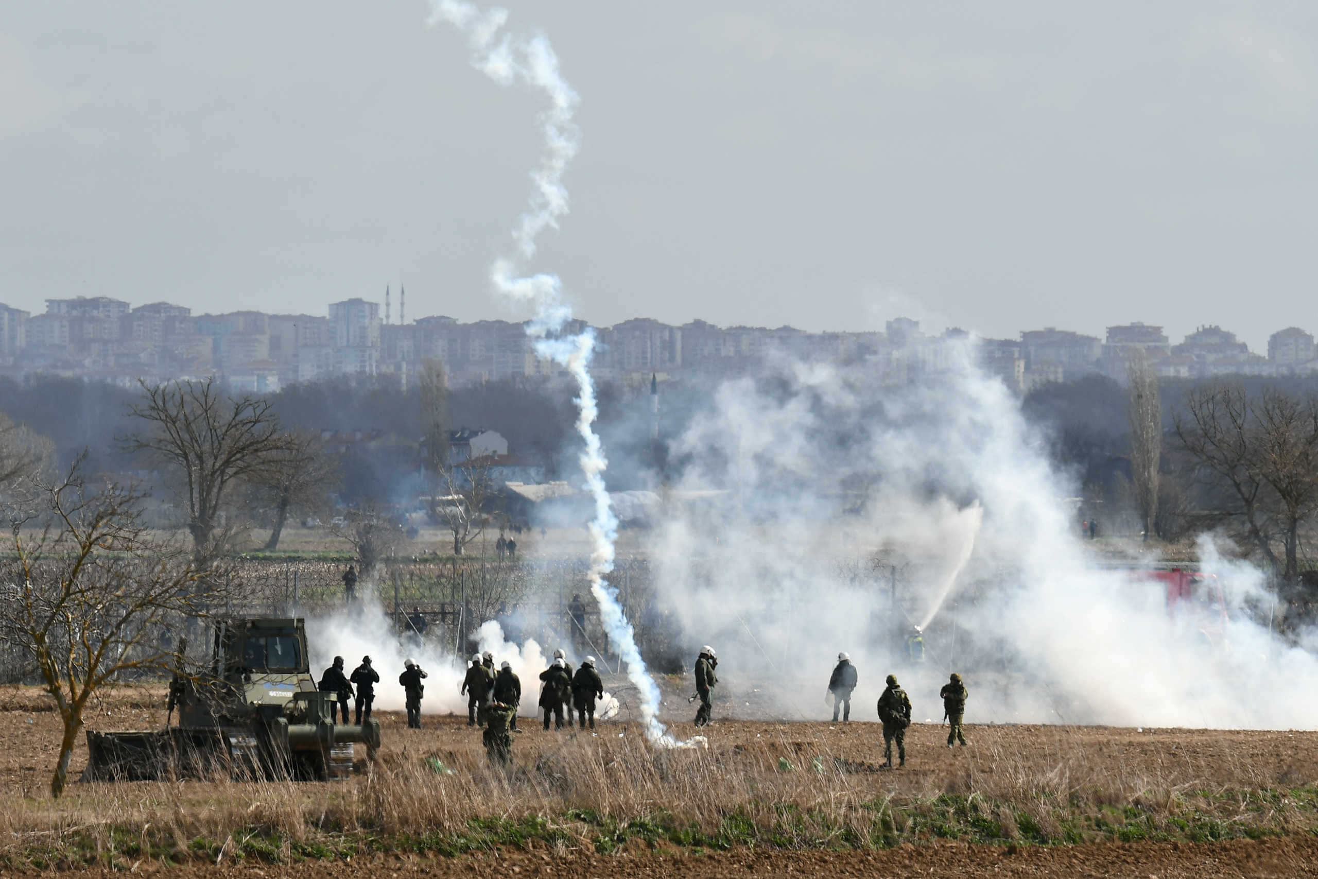 Greek riot police officers stand guard as tear gas is being fired near Turkey's Pazarkule border crossing, in Kastanies, Greece March 7, 2020. REUTERS