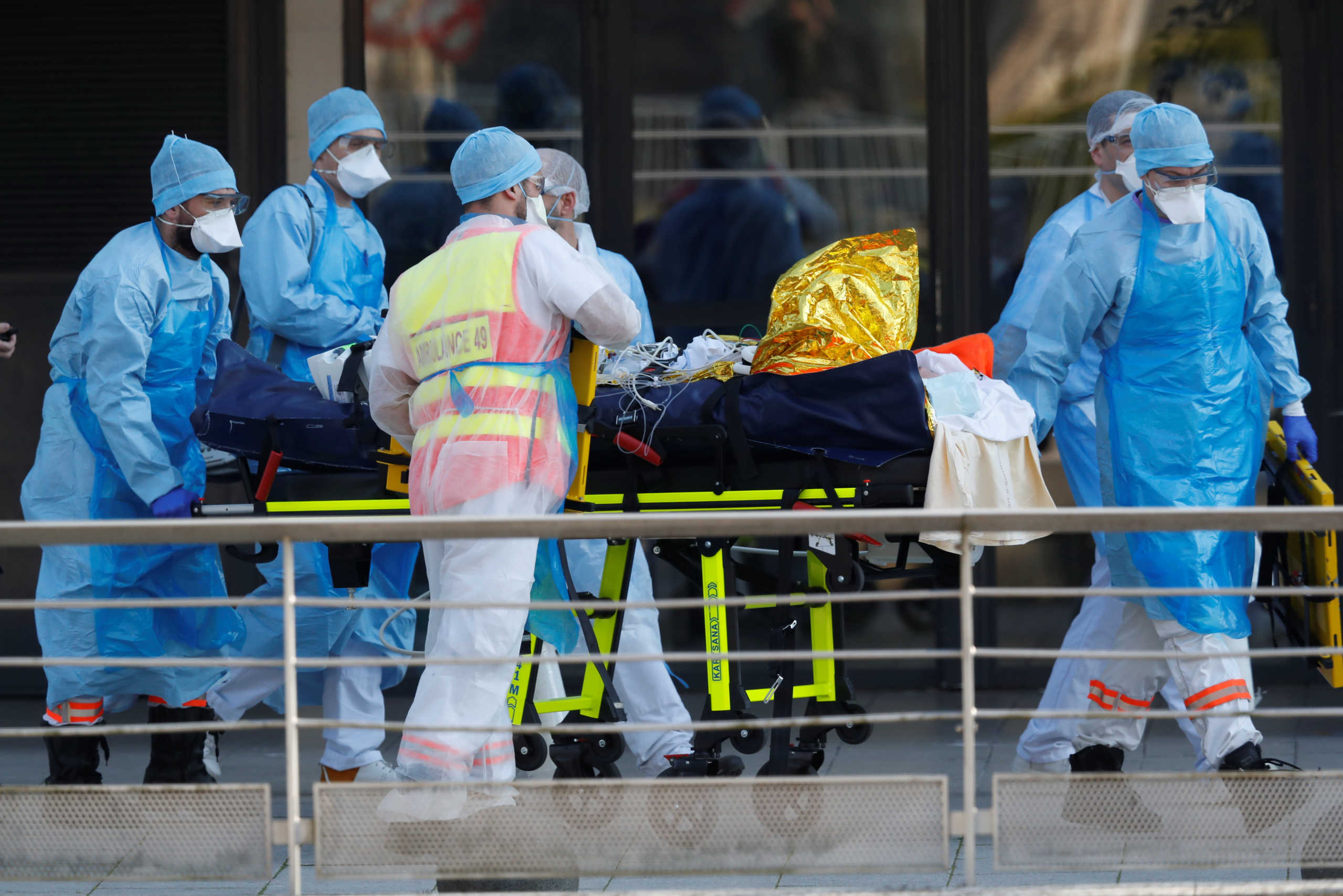 Medical staff move a patient from a special high-speed train to an ambulance during a transfer operation of people infected with coronavirus disease (COVID-19), from Strasbourg to western France hospitals, in Angers, France March 26, 2020. REUTERS