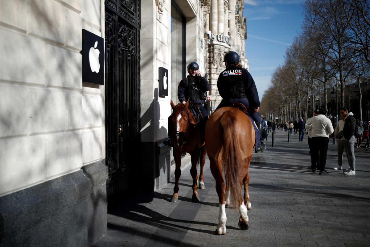 Police officers on horseback patrol in front of the Apple Store at Champs Elysees Avenue, which is closed as a measure to prevent the spread of coronavirus (COVID-19) disease in Paris, March 15, 2020. REUTERS