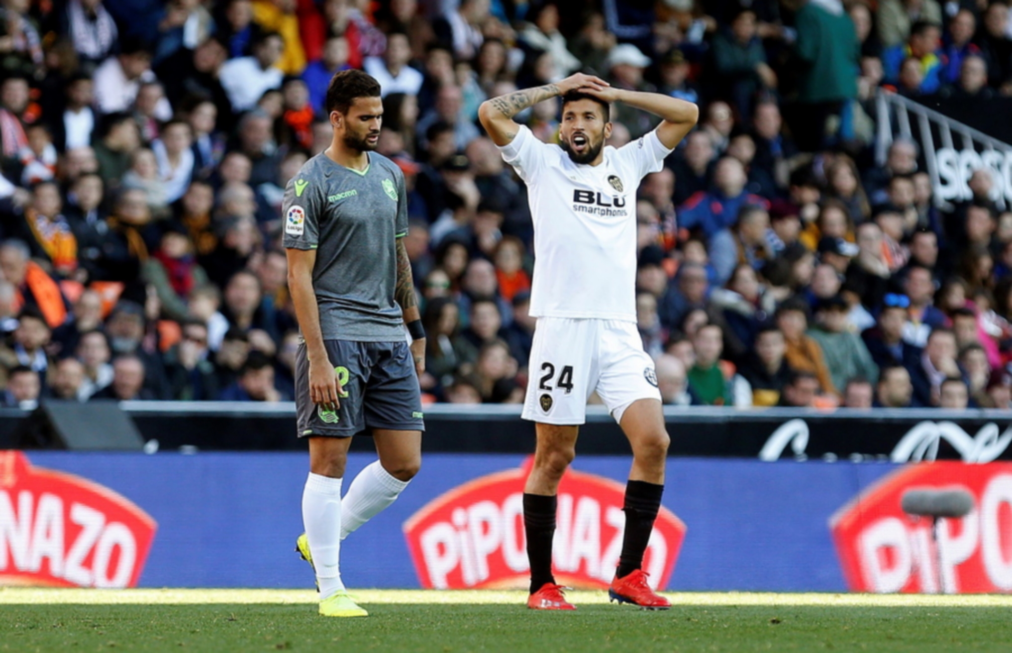 epa07359396 Real Sociedad's Willian Jose (L) and Valencia CF's Ezequiel Garay (R) react during a Spanish LaLiga soccer match between Valencia CF and Real Sociedad at the Mestalla stadium in Valencia, eastern Spain 10 February 2019.  EPA