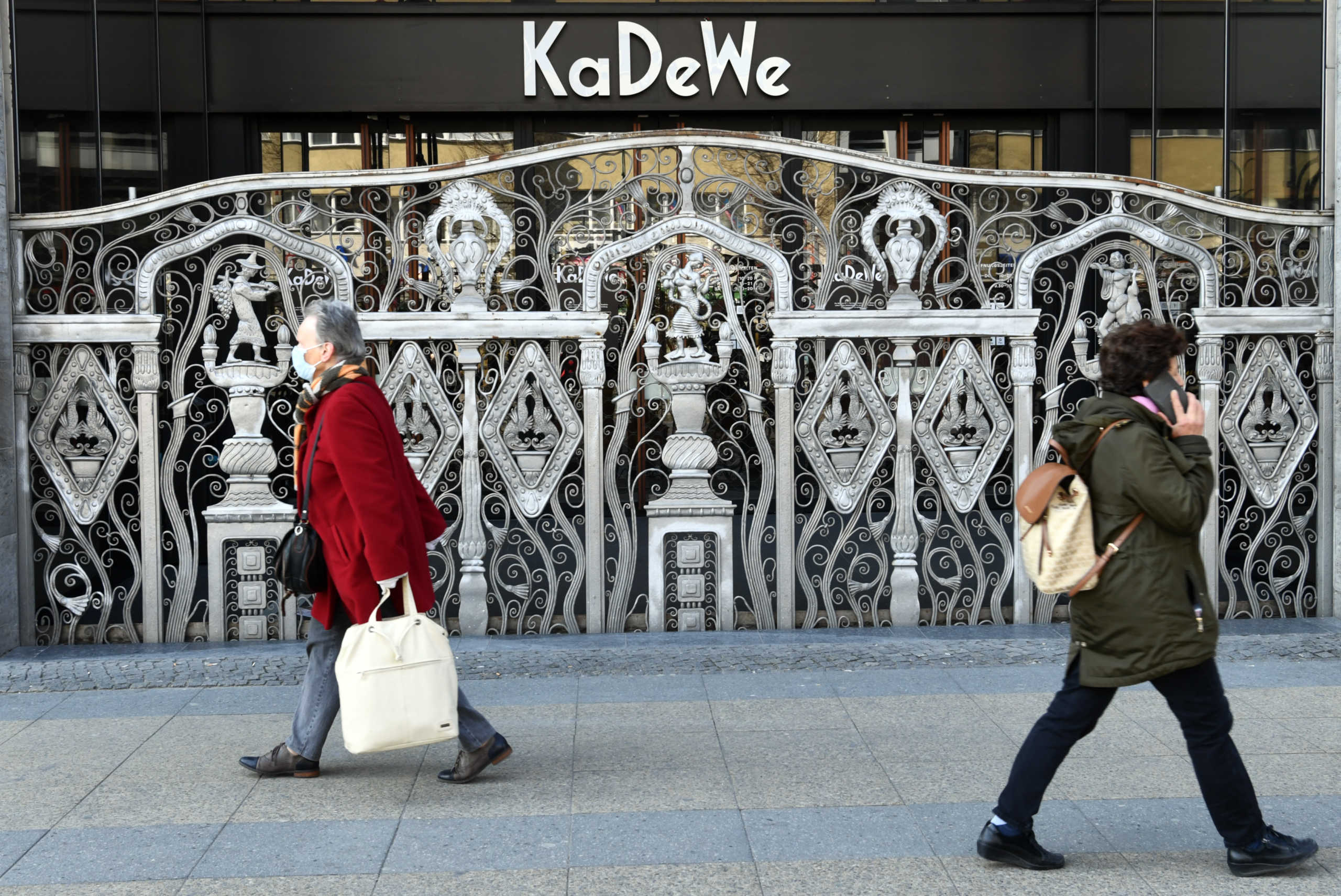 People walk past Berlin's famous KaDeWe shopping center on the Kurfuerstendamm boulevard during the spread of coronavirus disease (COVID-19) in Berlin, Germany, March 26, 2020. REUTERS