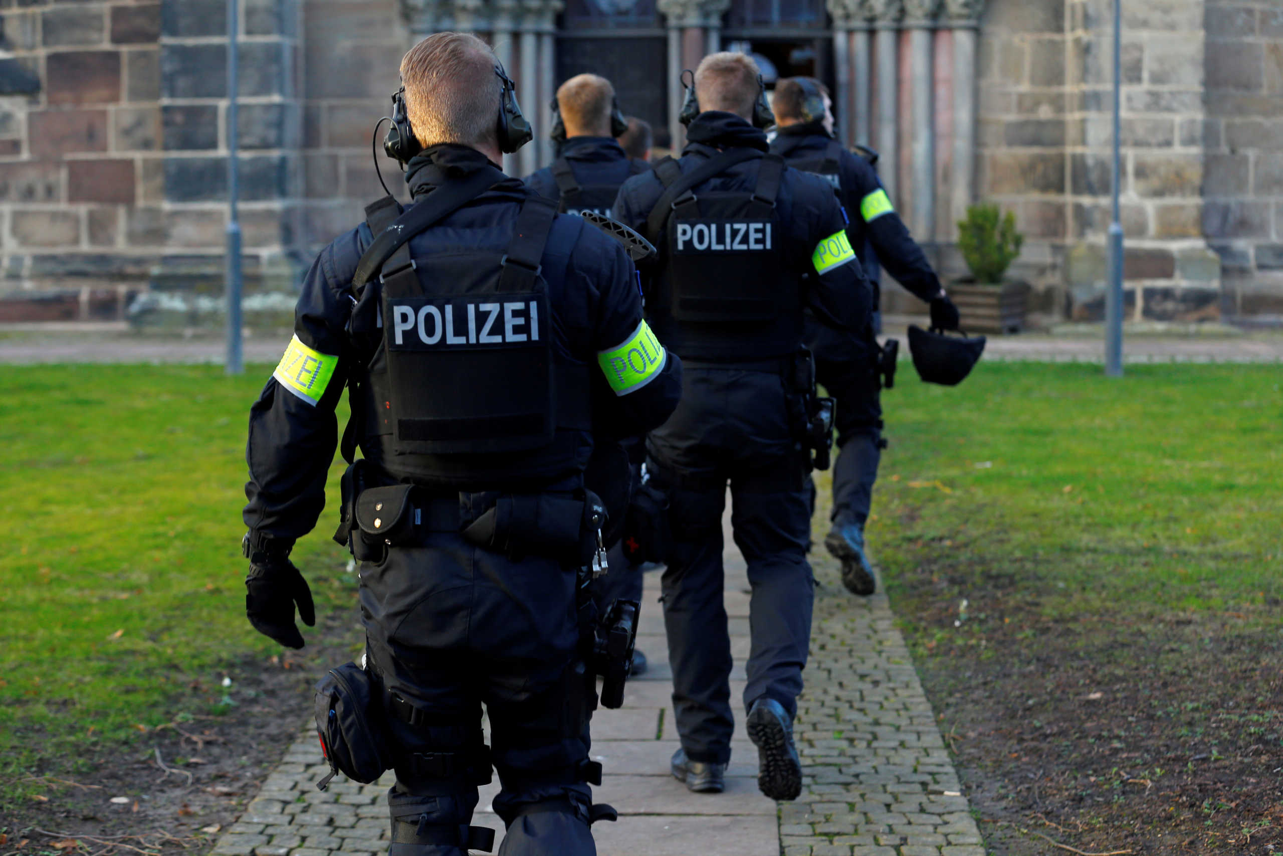 Police officers patrol as people enter the church, the day after a car ploughed into a Carnival parade, injuring several people in Volkmarsen, Germany February 25, 2020. REUTERS