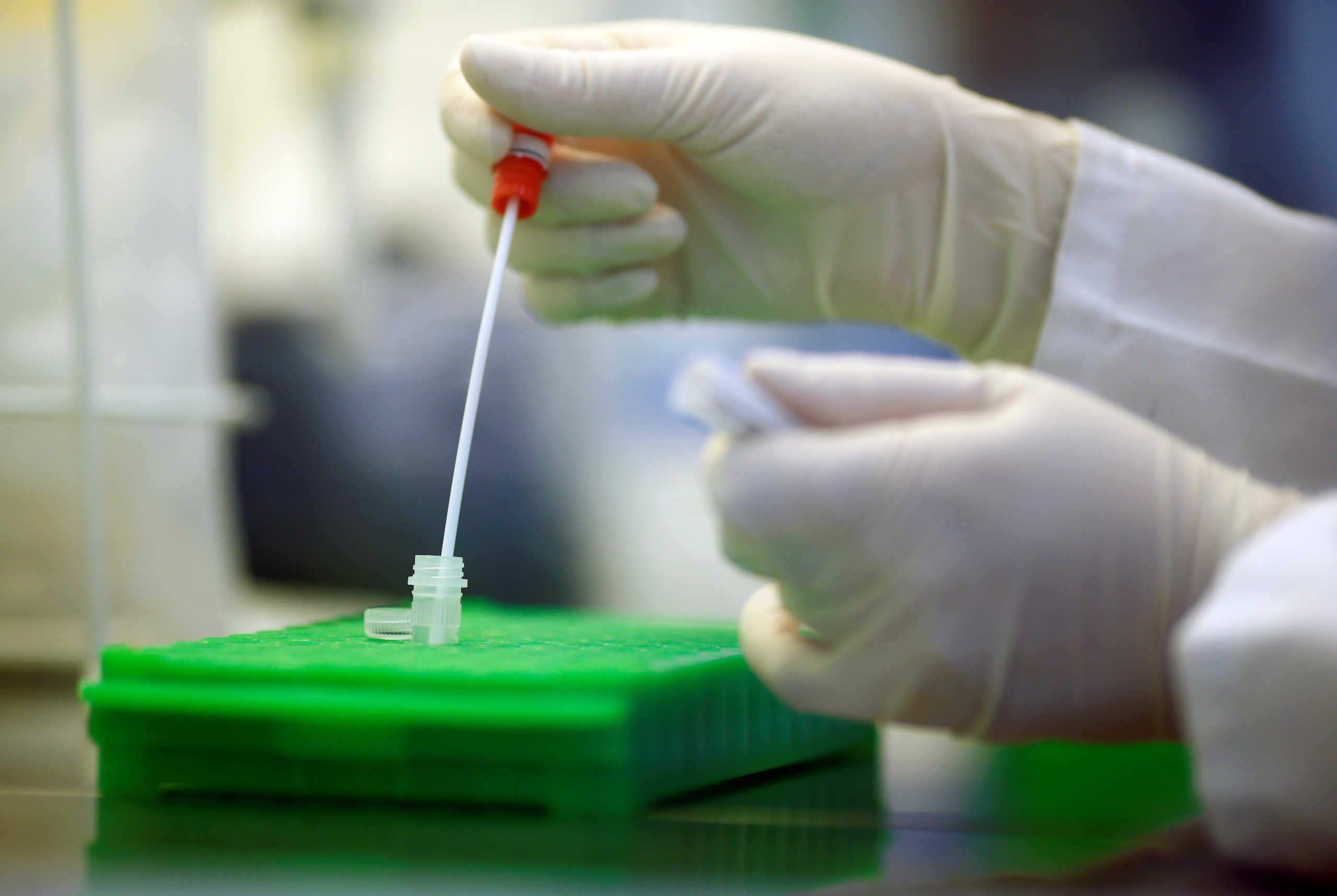An employee shows testing for the coronavirus at a medical laboratory in Cologne, Germany, March 24, 2020, as the spread of the coronavirus disease (COVID-19) continues. Picture taken March 24, 2020. REUTERS