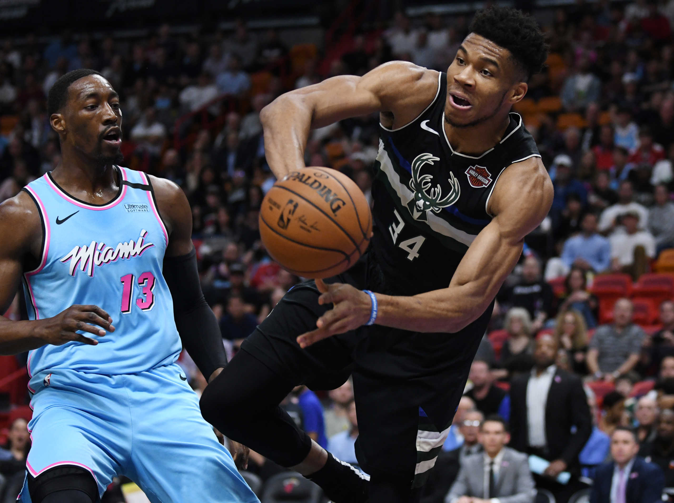 Mar 2, 2020; Miami, Florida, USA; Milwaukee Bucks forward Giannis Antetokounmpo (34) saves the ball from going out of bounds as Miami Heat forward Bam Adebayo (13) follows on the play in the first quarter at American Airlines Arena. Mandatory Credit: Jim Rassol-USA TODAY Sports