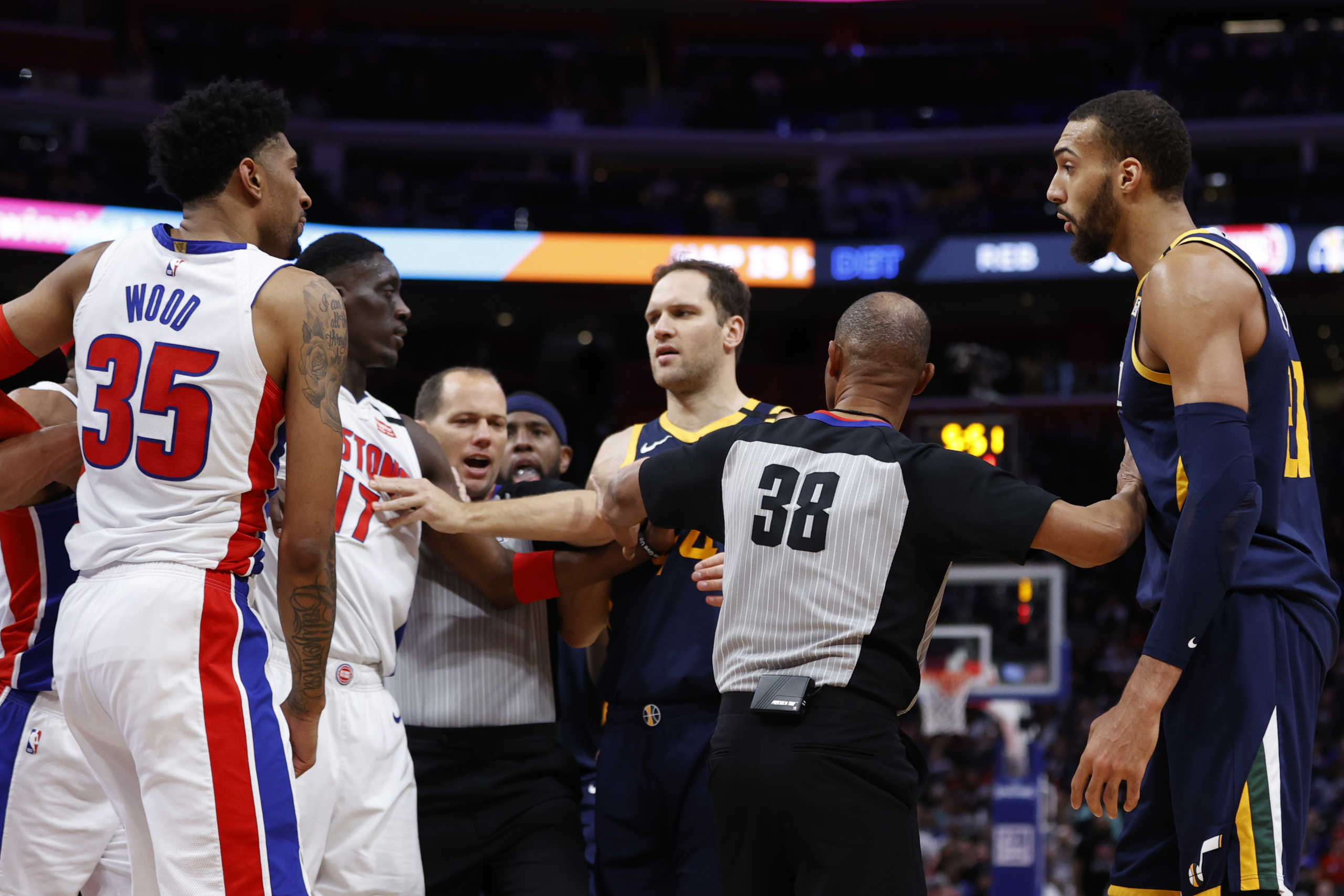 Mar 7, 2020; Detroit, Michigan, USA; NBA referee Michael Smith (38) separates Detroit Pistons forward Tony Snell (17) and Utah Jazz center Rudy Gobert (right) during the second half at Little Caesars Arena. Mandatory Credit: Rick Osentoski-USA TODAY Sports