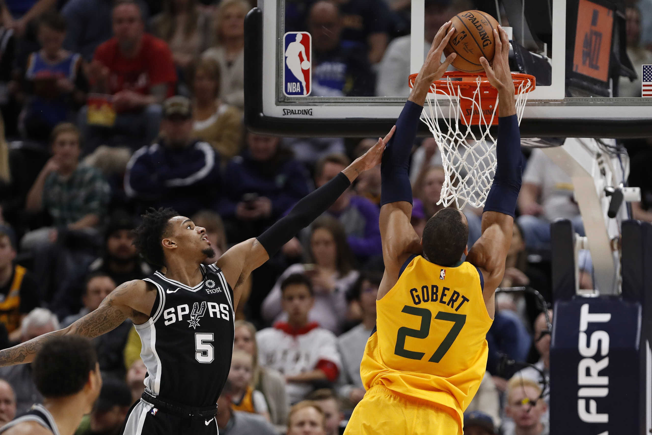 Feb 21, 2020; Salt Lake City, Utah, USA;  Utah Jazz center Rudy Gobert (27) dunks against San Antonio Spurs guard Dejounte Murray (5) during the second quarter at Vivint Smart Home Arena. Mandatory Credit: Jeffrey Swinger-USA TODAY Sports