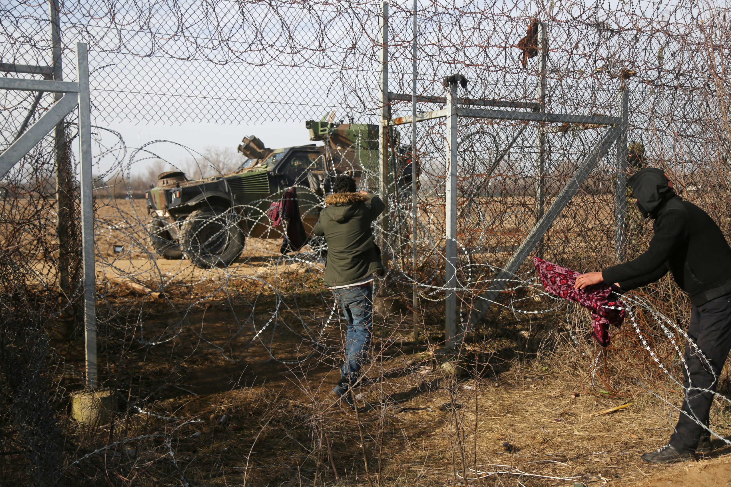 Migrants try to bring down part of a border fence on the Turkish-Greek border at Turkey's Pazarkule border crossing with Greece's Kastanies, near Edirne, Turkey, March 2, 2020. REUTERS
