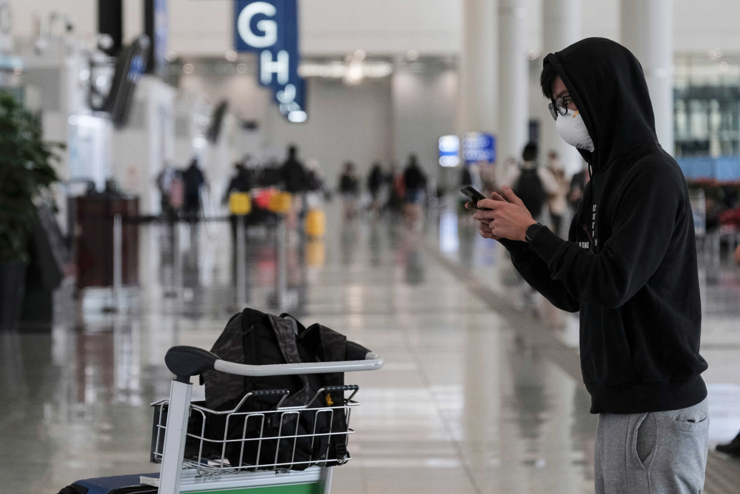A passenger wears a protective face mask at the airport, following the outbreak of the new coronavirus, in Hong Kong, China March 5, 2020. REUTERS