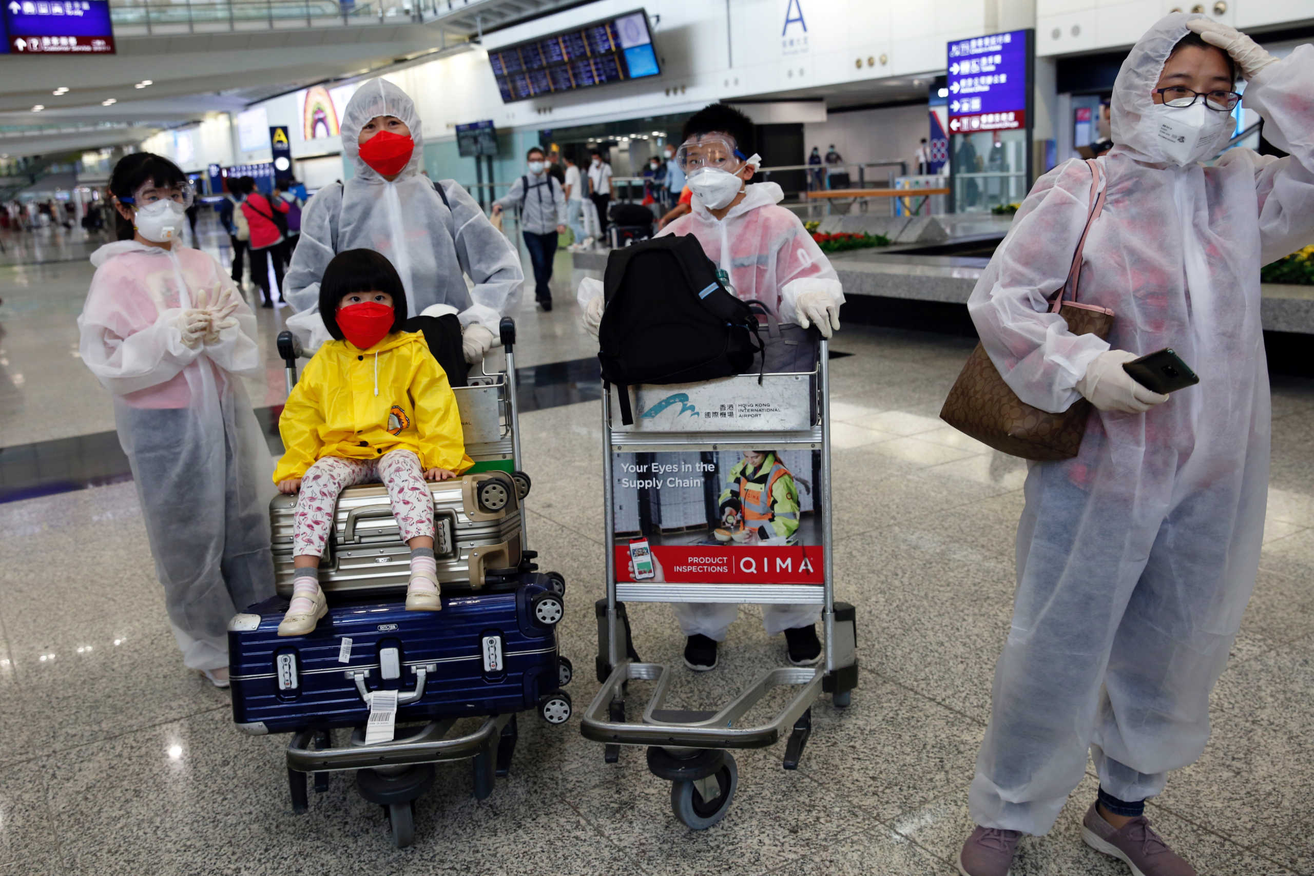 Passengers wear protective suits, amid the outbreak of coronavirus, at Hong Kong International Airport, Hong Kong, China March 17, 2020. REUTERS