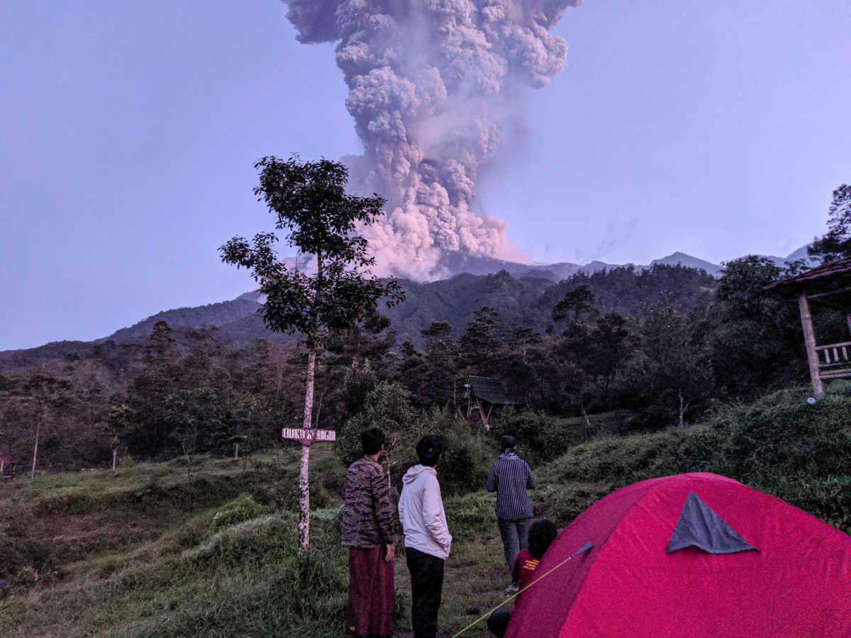 Tourists look towards Mount Merapi volcano as it erupts, at Cangkringan district in Sleman, Yogyakarta, Indonesia March 3, 2020 in this photo taken by Antara Foto. Antara Foto