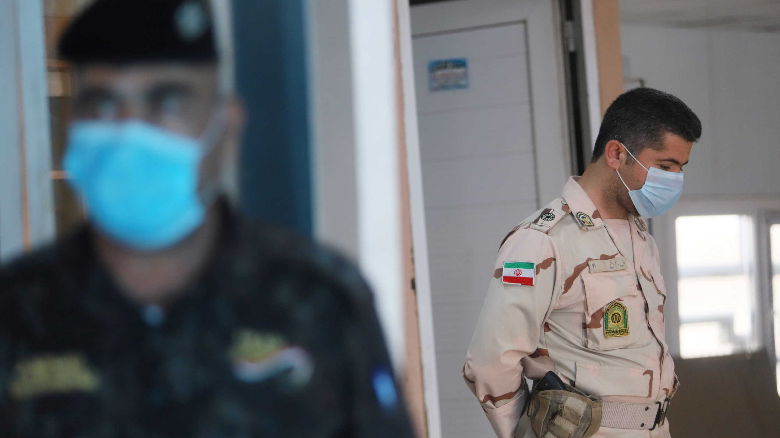 A member of Iranian Border Guards wears a protective face mask, following an outbreak of the new coronavirus, inside the Shalamcha Border Crossing, after Iraq shut a border crossing to travellers between Iraq and Iran, Iraq March 8, 2020. REUTERS