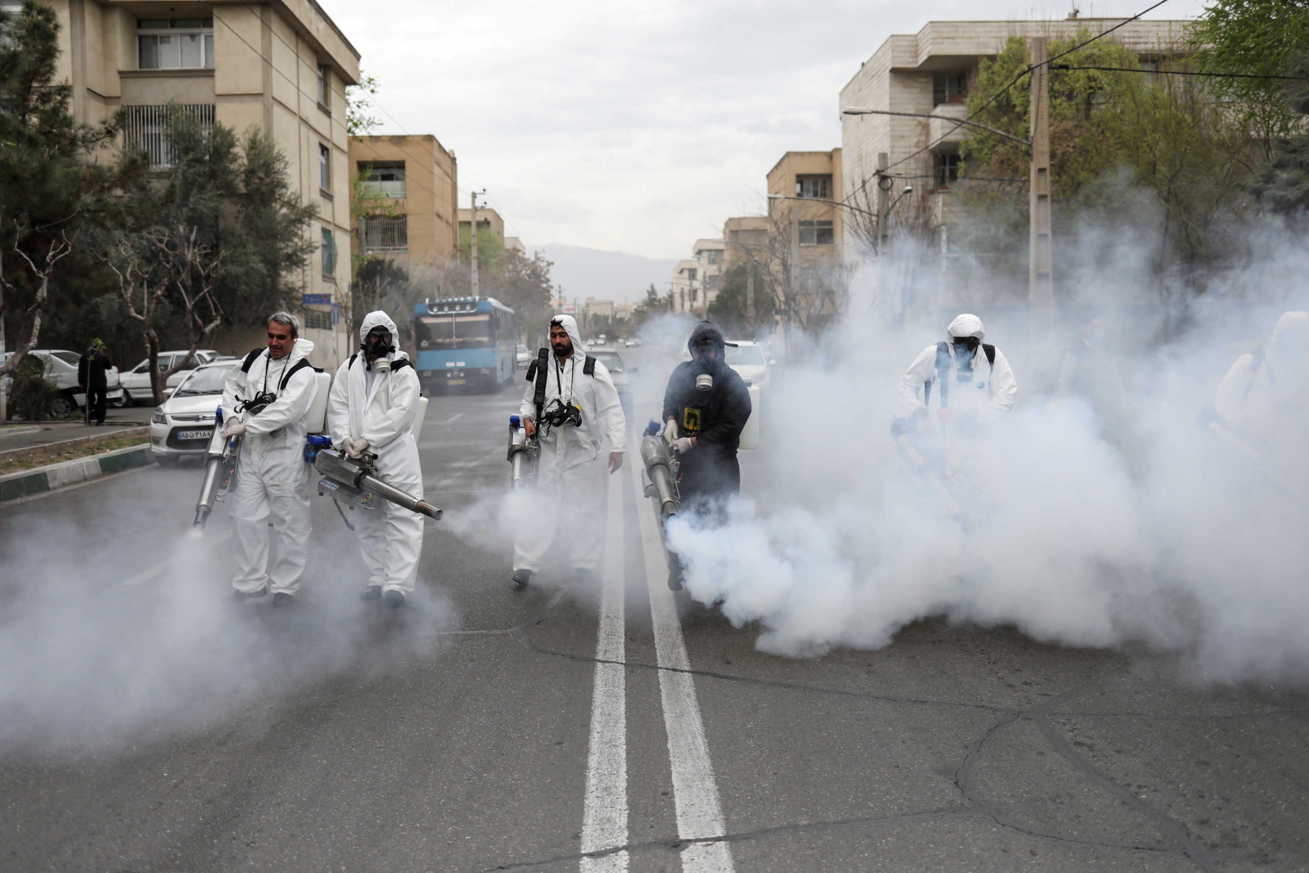 FILE PHOTO: Members of firefighters wear protective face masks, amid fear of coronavirus disease (COVID-19), as they disinfect the streets, ahead of the Iranian New Year Nowruz, March 20, in Tehran, Iran March 18, 2020. Picture taken March 18, 2020. WANA (West Asia News Agency)