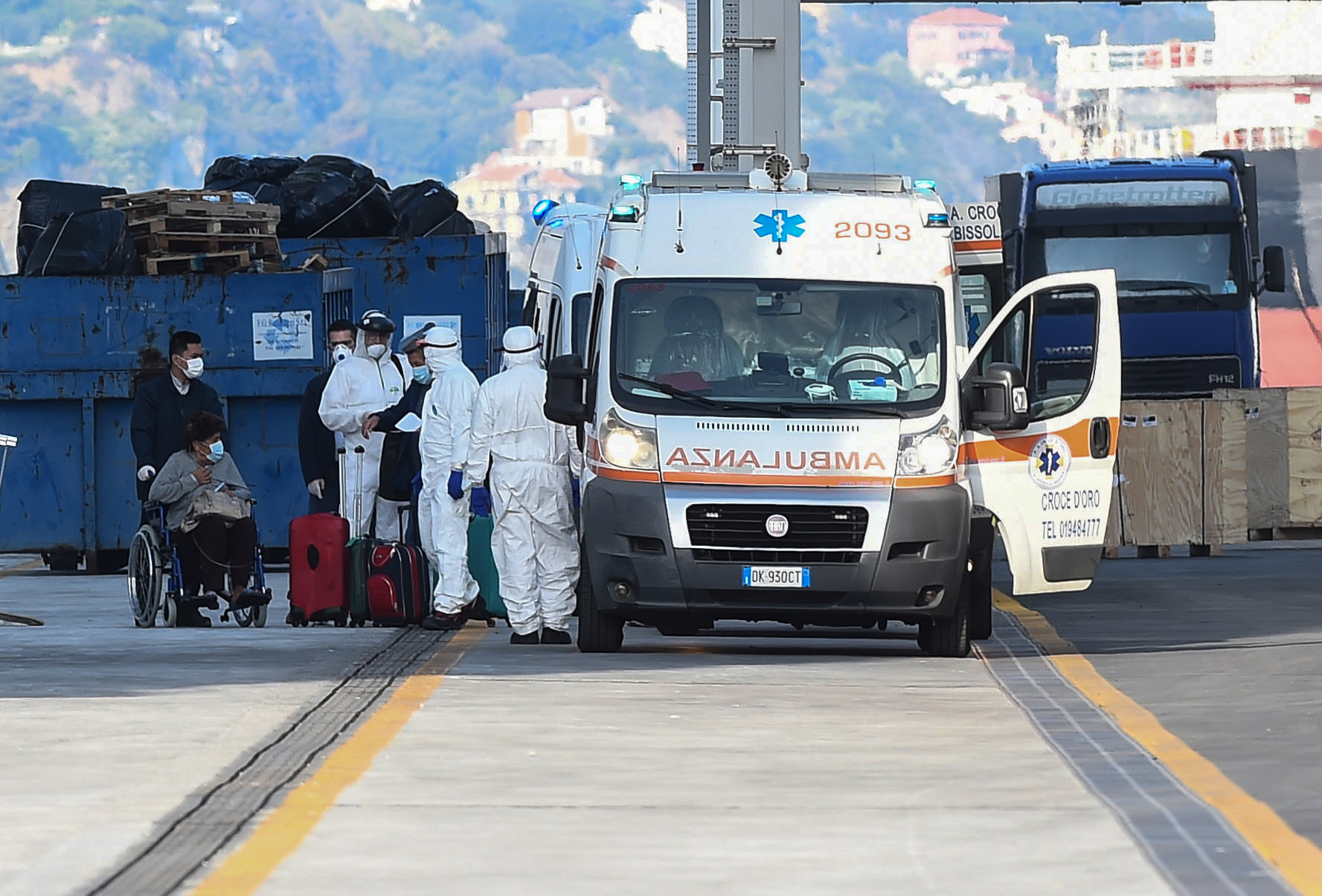 Passengers from the the Costa Luminosa cruise ship that was hit by the coronavirus disease (COVID-19) are led from a ship to an ambulance , at the port of Savona, near Genoa, in Italy, March 21, 2020. REUTERS