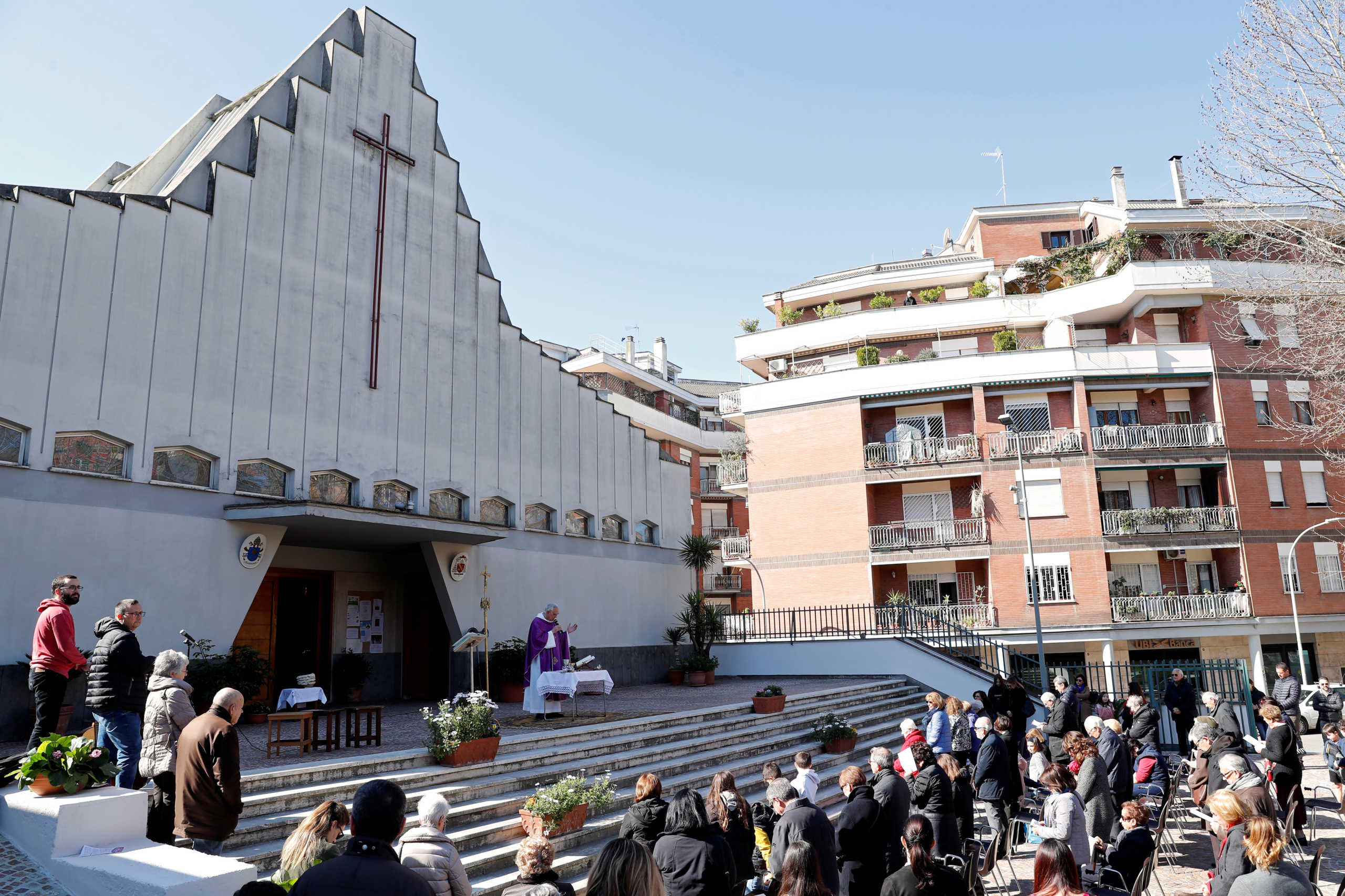 A priest celebrates Mass in the open air, after Italy's bishops ordered Masses not be held in churches in order to contain the coronavirus outbreak, in Rome, Italy March 8, 2020. REUTERS