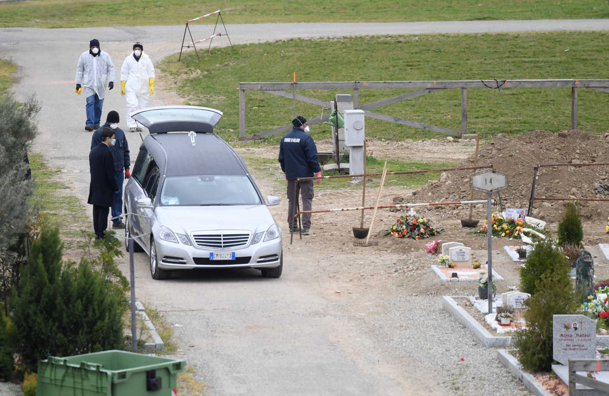 Workers arrive a cemetery, as the spread of the coronavirus disease (COVID-19) continues, in Milan, Italy March 23, 2020. REUTERS
