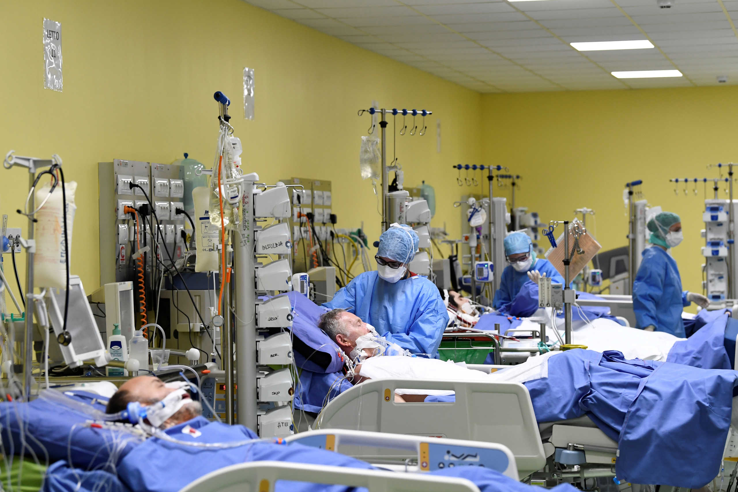 SENSITIVE MATERIAL. THIS IMAGE MAY OFFEND OR DISTURB Members of the medical staff in protective suits treat patients suffering from coronavirus disease (COVID-19) in an intensive care unit at the San Raffaele hospital in Milan, Italy, March 27, 2020. REUTERS