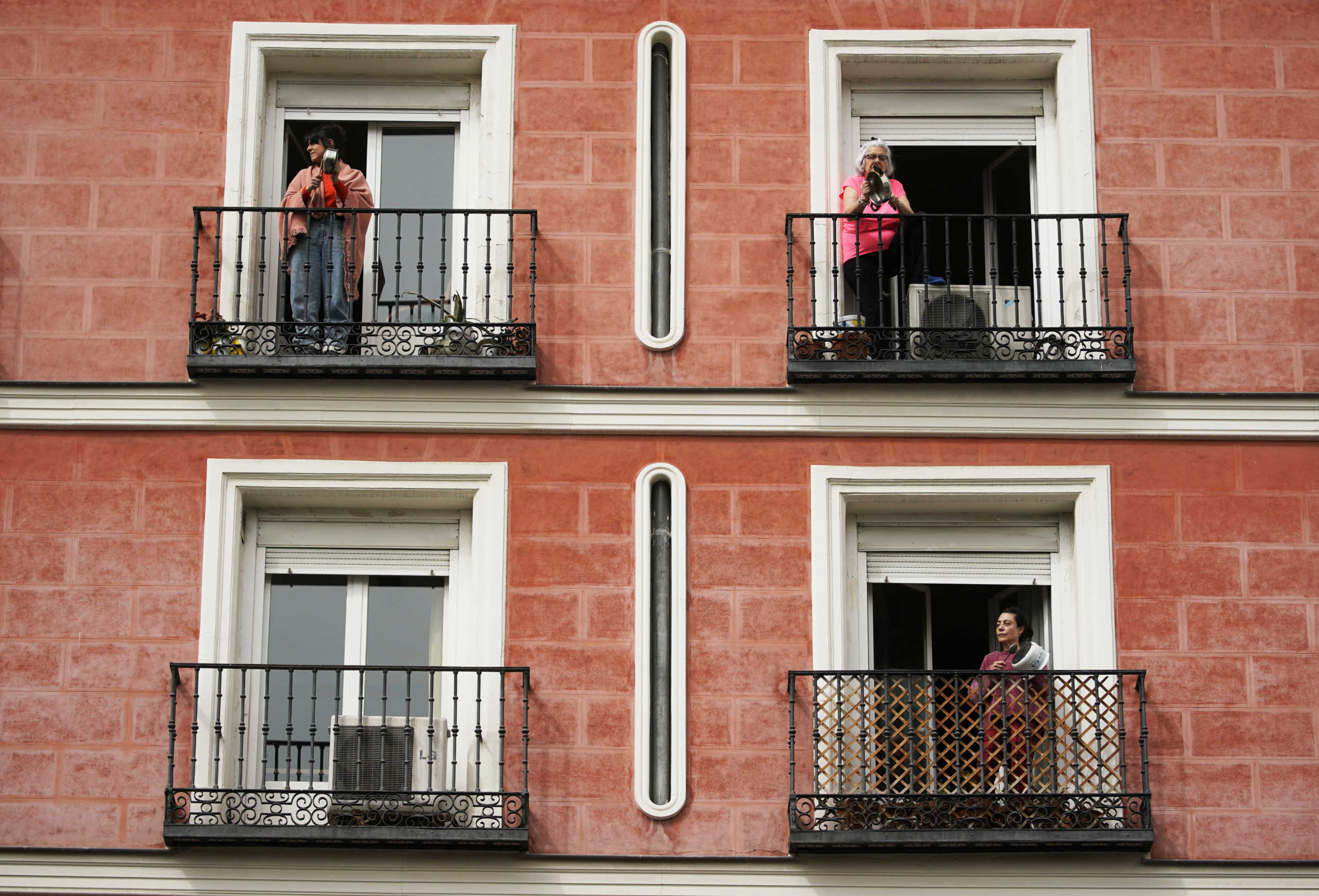 People bang on saucepans with spoons on their balconies demanding from former King Juan Carlos to donate 100 million dollars, he allegedly received from Saudi Arabia's late king, to the Spanish health system currently struggling to combat coronavirus, during the coronavirus disease (COVID-19) health emergency in Madrid, Spain, March 18, 2020. REUTERS