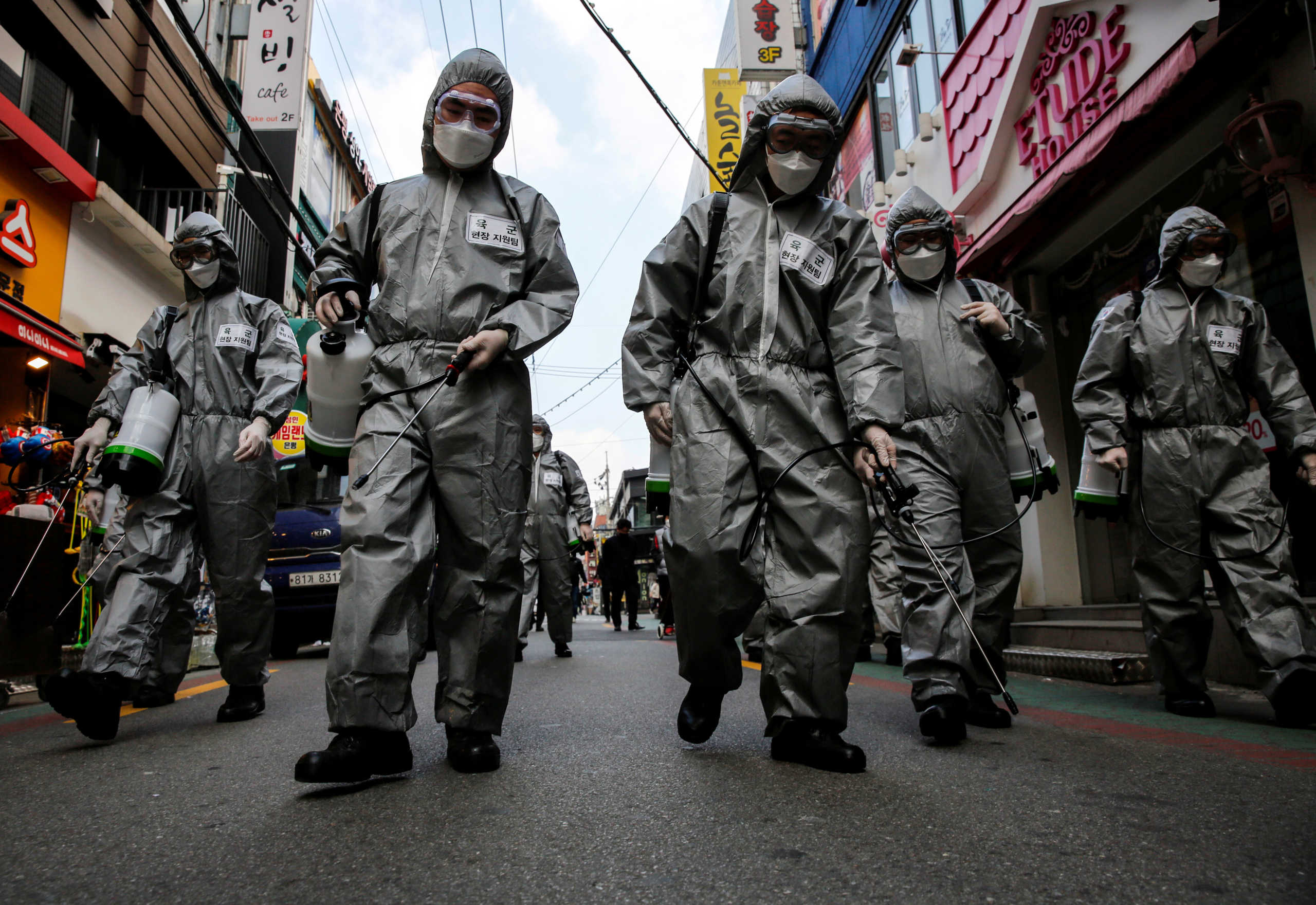 South Korean soldiers in protective gear sanitize?a shopping street in Seoul, South Korea, March 4, 2020.    REUTERS
