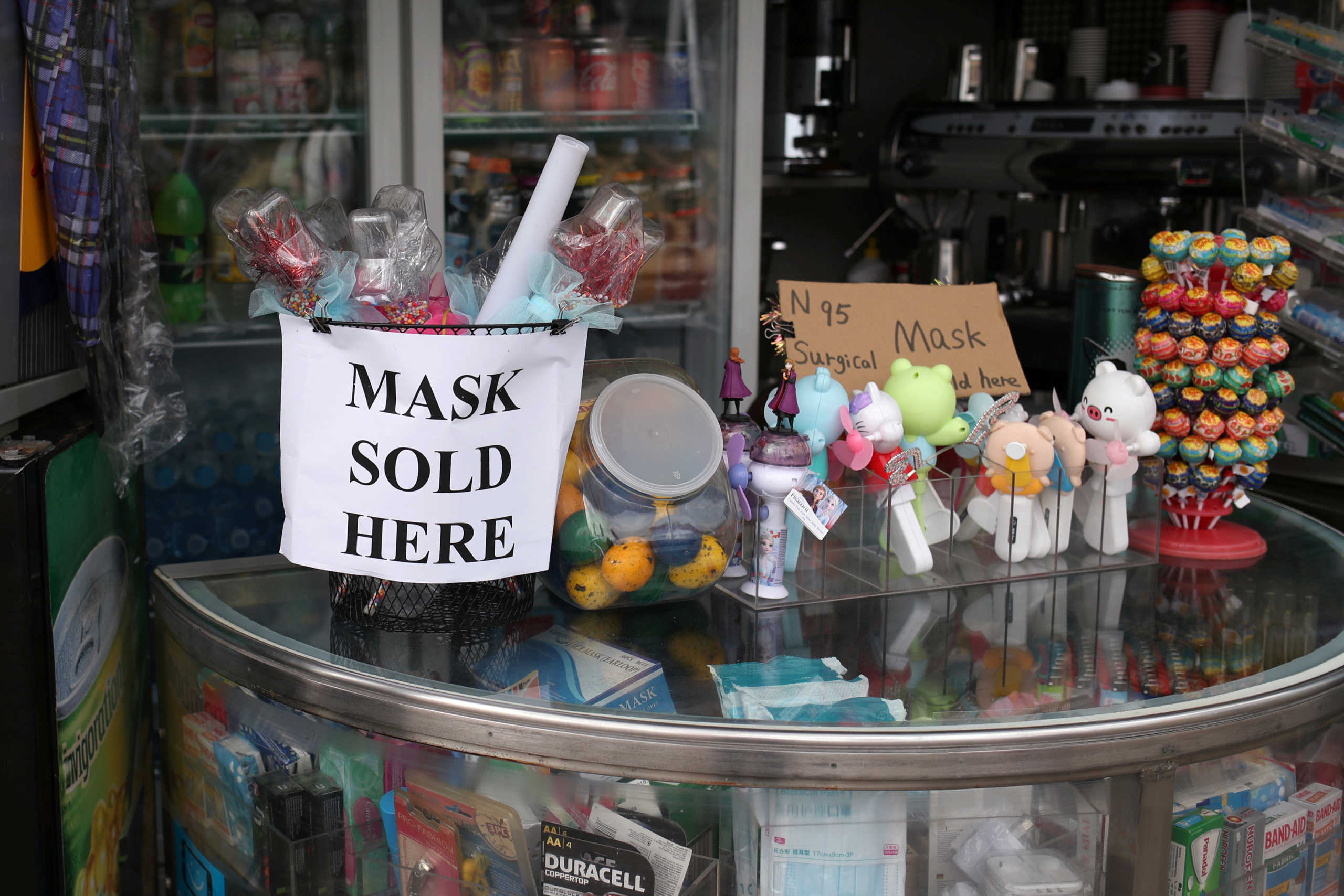 A sign advertising the sale of masks is displayed in a shop as New South Wales began shutting down non-essential businesses and moving toward harsh penalties to enforce self-isolation as the spread of coronavirus disease (COVID-19) reached a "critical stage" in Sydney, Australia, March 24, 2020.  REUTERS