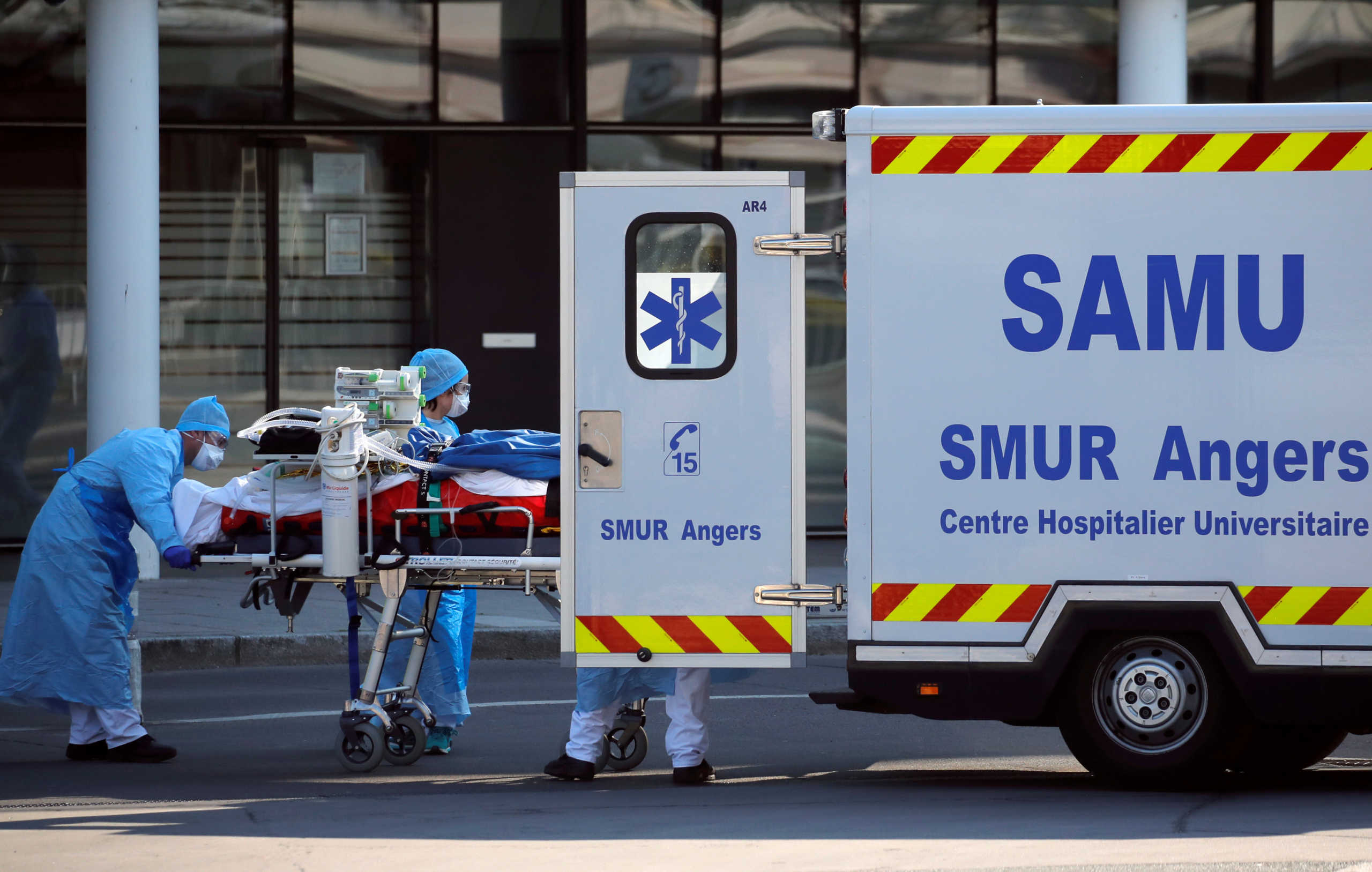 Medical staff move a patient from a special high-speed train to an ambulance during a transfer operation of people infected with coronavirus disease (COVID-19), from Strasbourg to western France hospitals, in Angers, France March 26, 2020. REUTERS