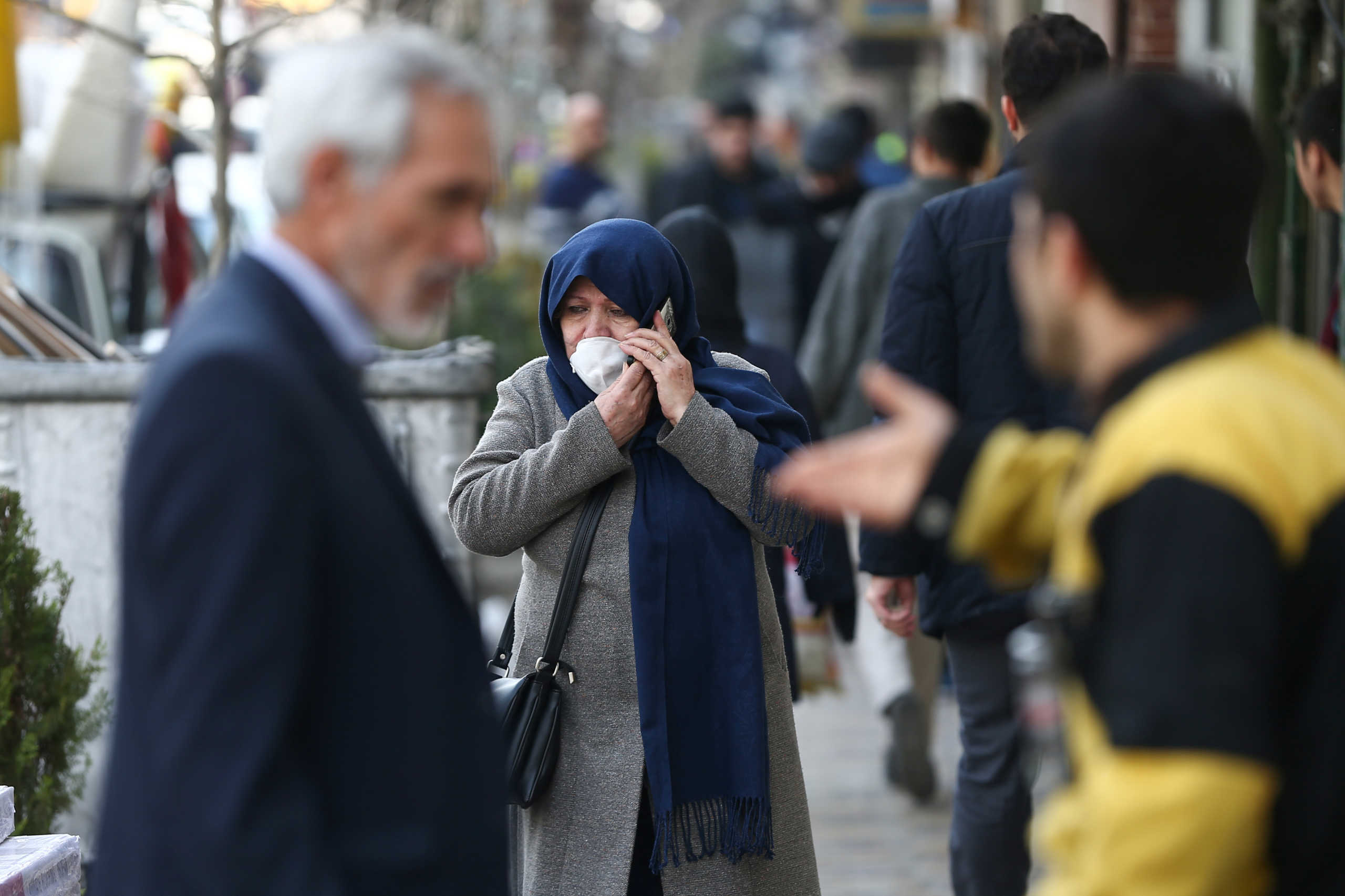 An Iranian woman wears a protective face mask, following the coronavirus outbreak, as she talks on the phone, in Tehran, Iran March 5, 2020. WANA (West Asia News Agency)