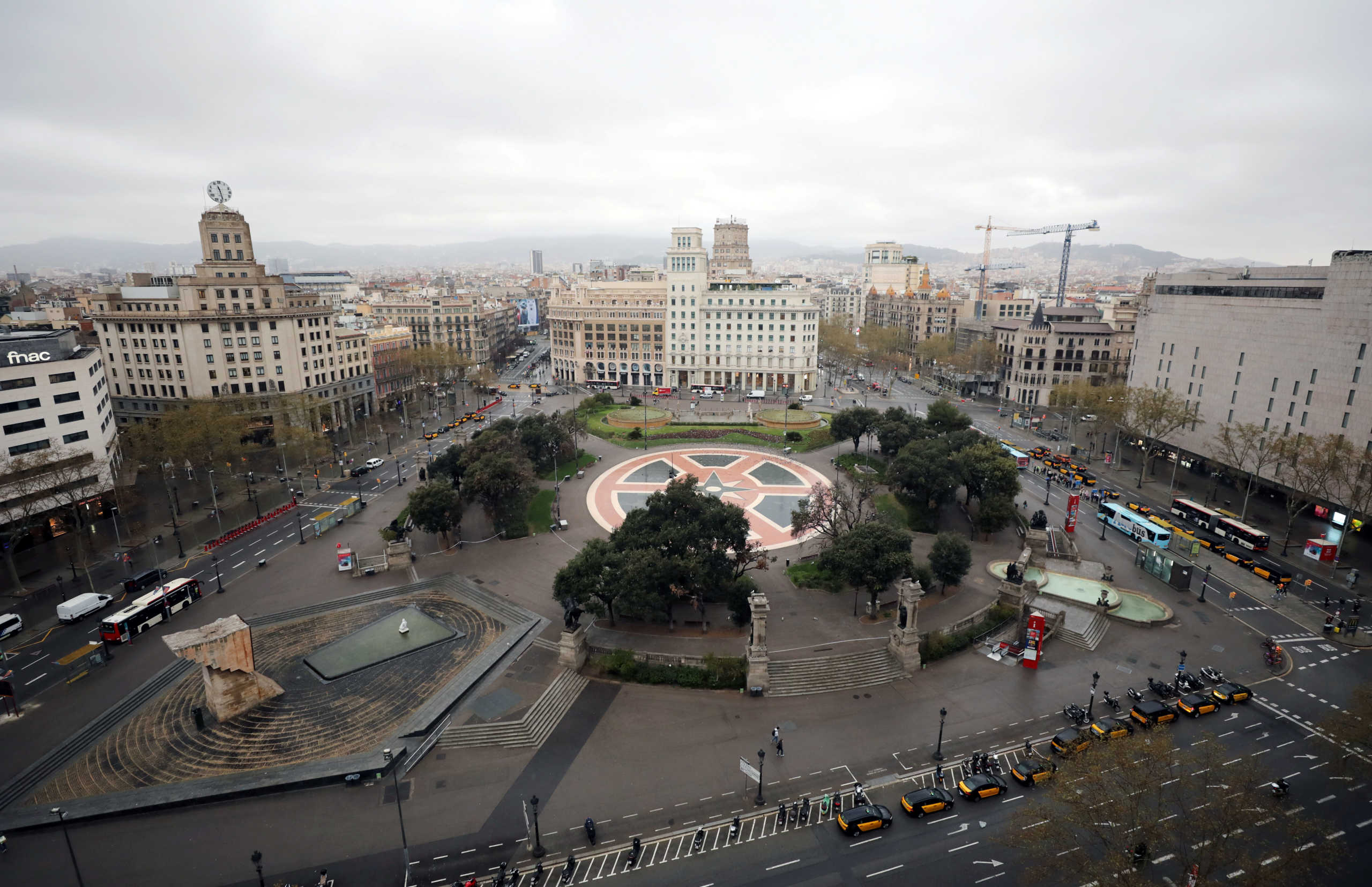 A general view of empty Plaza de Catalunya (Catalonia Square) during partial lockdown as part of a 15-day state of emergency to combat the coronavirus disease outbreak, in Barcelona, Spain March 16, 2020. REUTERS