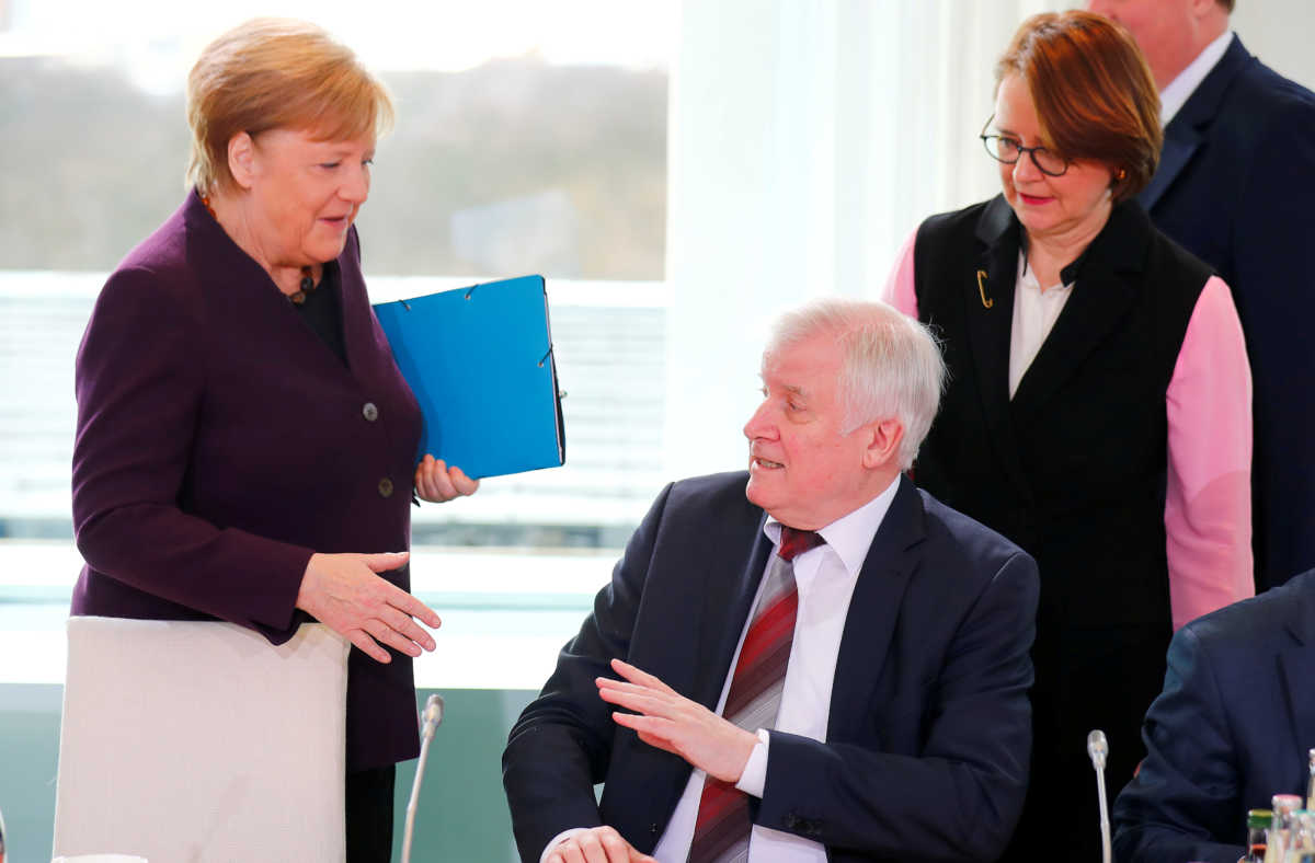 German Interior Minister Horst Seehofer refuses to shake the hand of German Chancellor Angela Merkel for hygienic reasons before a migration summit at the Chancellery in Berlin, Germany, March 2, 2020. REUTERS
