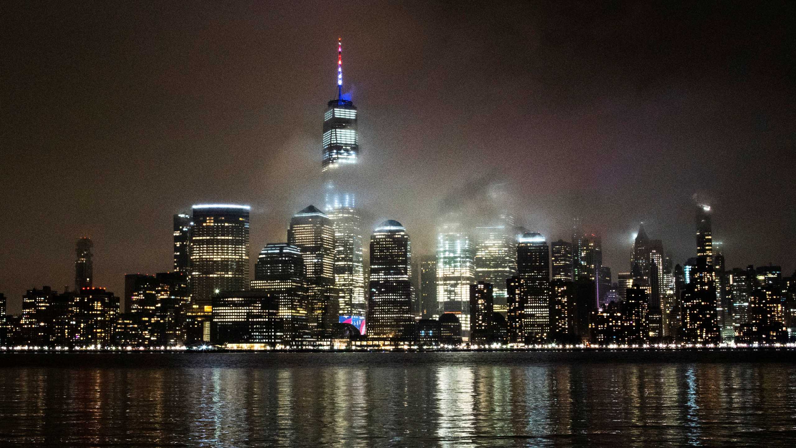 The One World Trade Center is illuminated in red, white and blue in recognition of the ongoing nationwide effort to combat coronavirus during the outbreak of the coronavirus disease (COVID-19) in New York City, as it is seen from Exchange Place, New Jersey, U.S., March 30, 2020. REUTERS