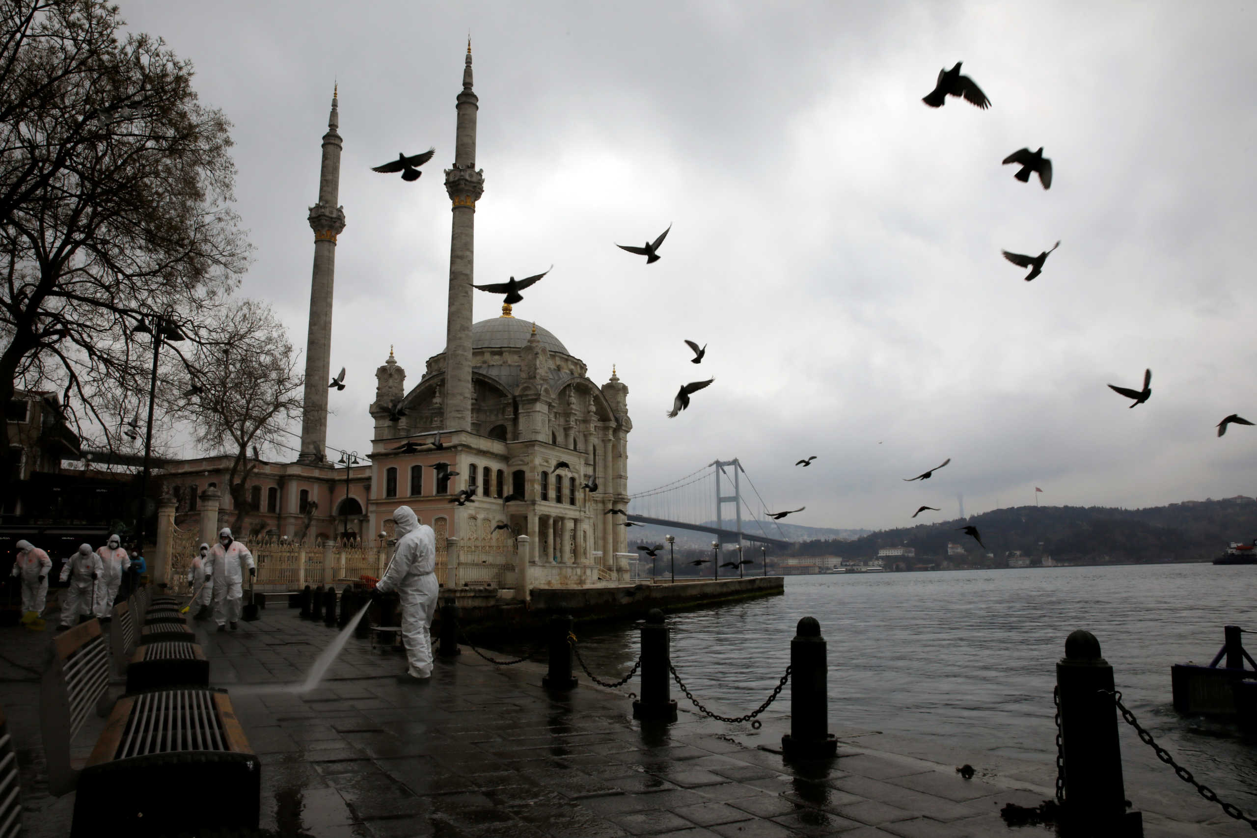 A worker sprays disinfectant outside Ortakoy Mosque, to prevent the spread of coronavirus disease (COVID-19), in Istanbul, Turkey, March 23, 2020. REUTERS