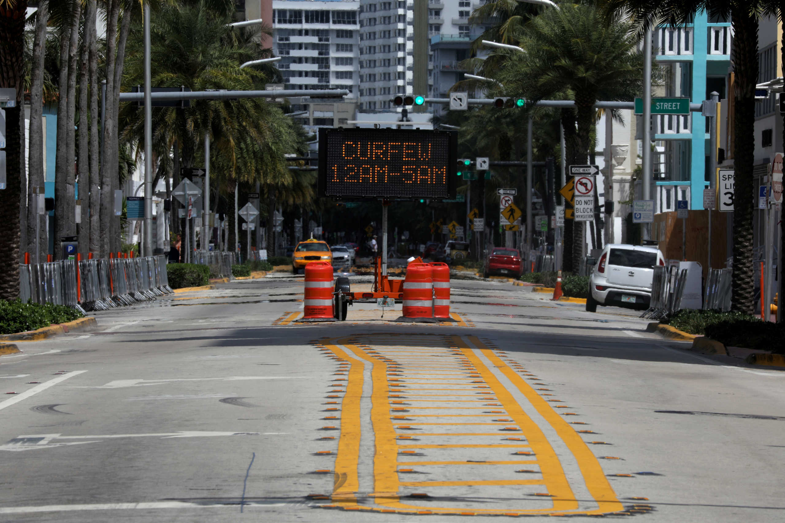 A traffic sign which reads 'Curfew 12am-5am is seen in Miami Beach after local authorities order the closing of all the beaches for precaution due to coronavirus disease (COVID-19) spread, in Miami, Florida, U.S., March 22, 2020. REUTERS