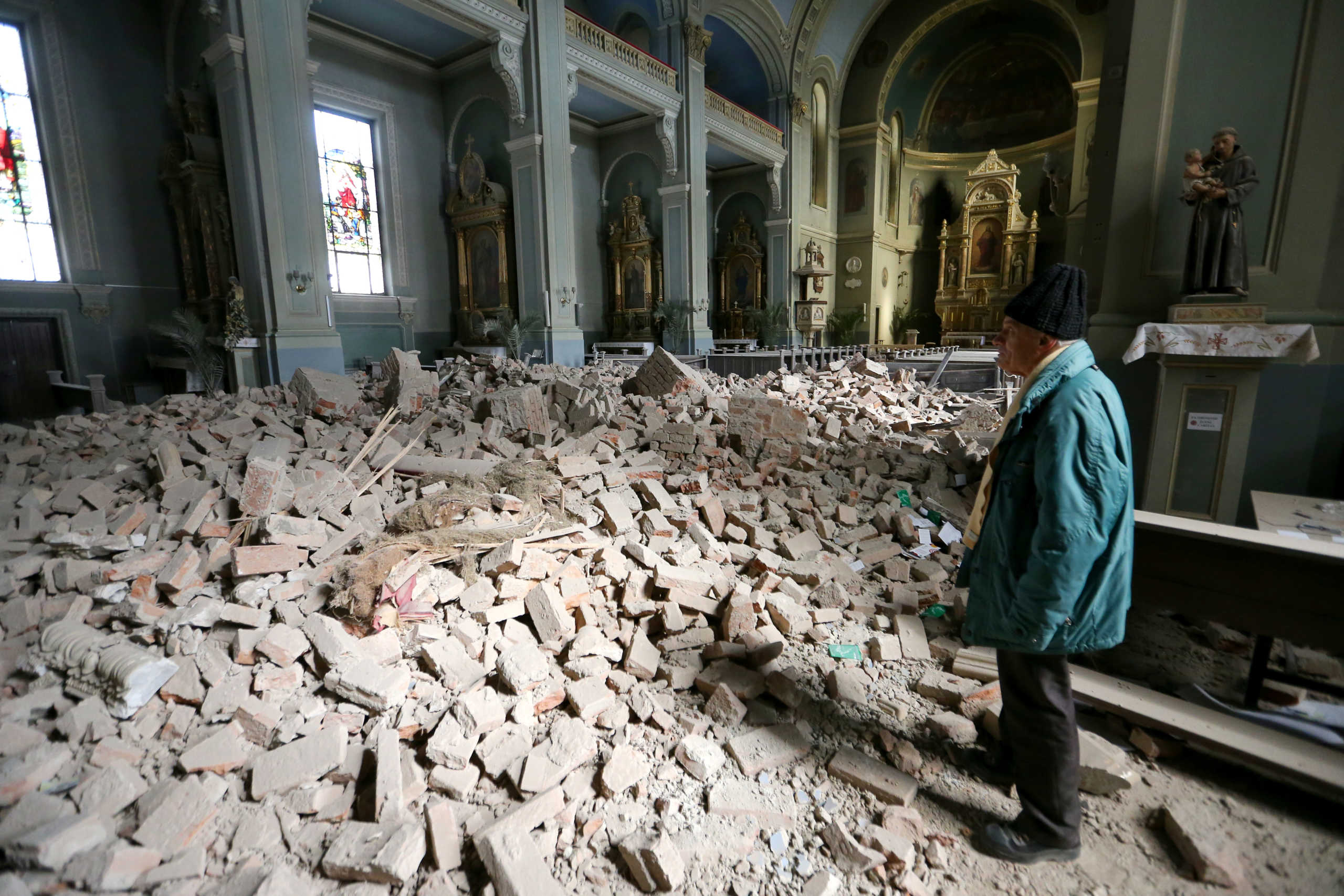 A man looks at damages at the Basilica of the Heart of Jesus, following an earthquake in Zagreb, Croatia March 22, 2020. REUTERS