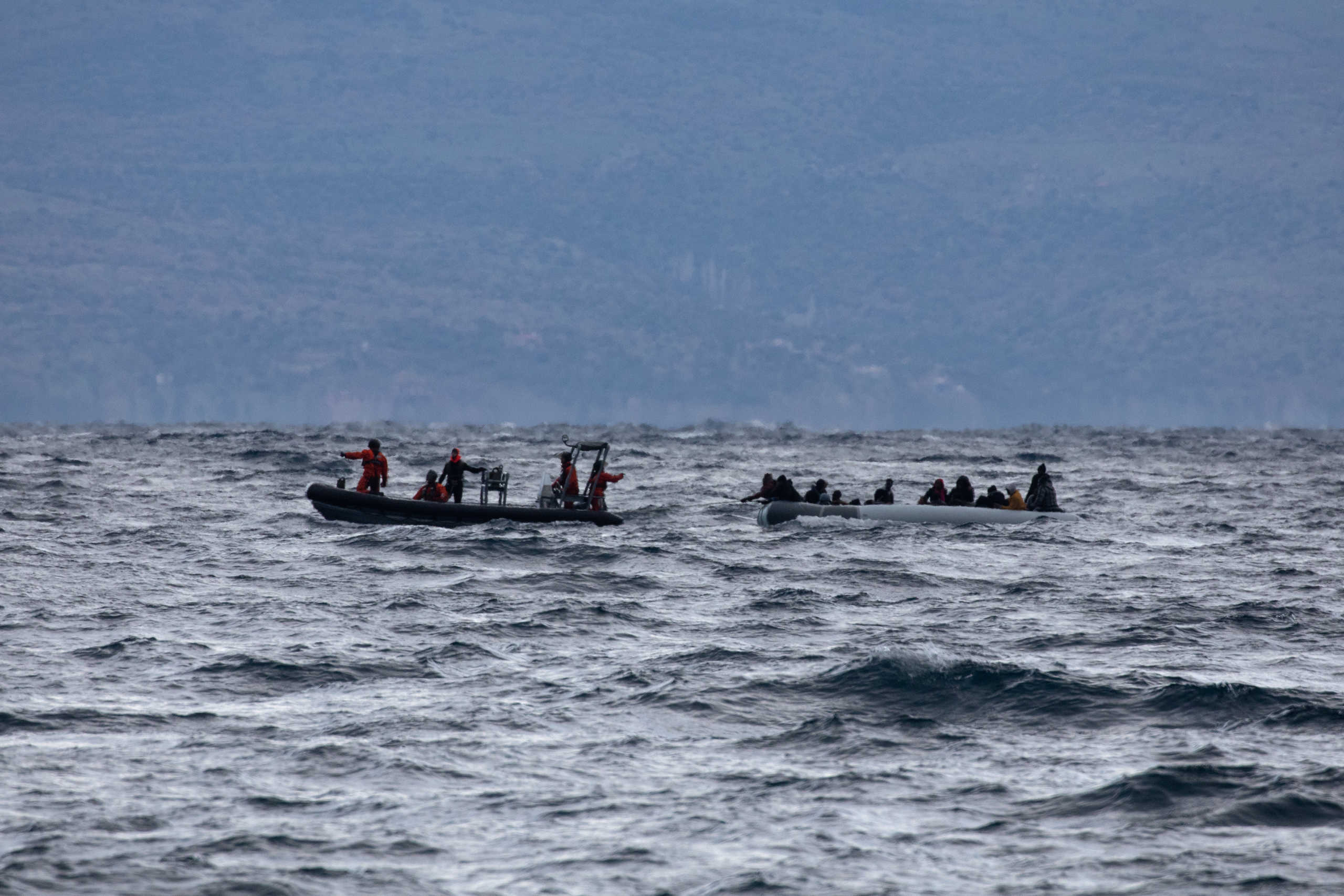 Migrants from sub-saharan African countries on a dinghy are towed by a rescue boat as they try to cross part of the Aegean Sea from Turkey to the island of Lesbos, Greece, February 29, 2020. REUTERS