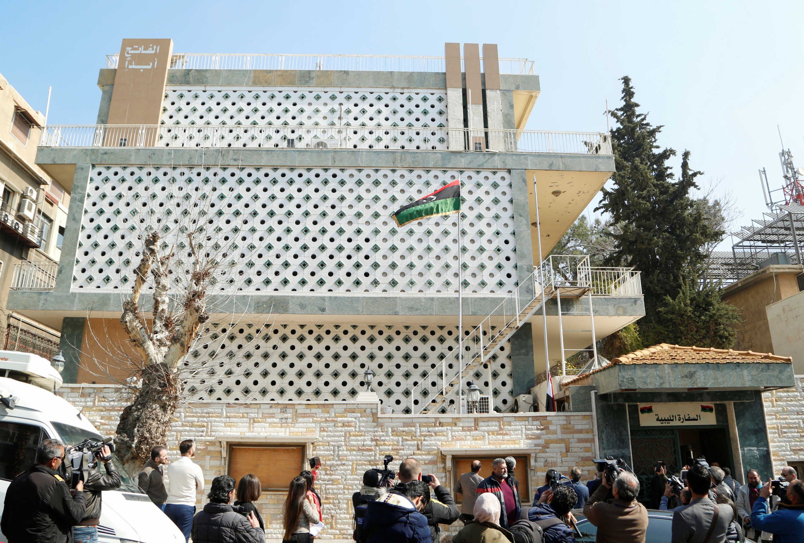 Journalists stand outside the embassy of Libya's eastern-based government led by military commander Khalifa Haftar, that opened in Damascus, Syria March 3, 2020. REUTERS
