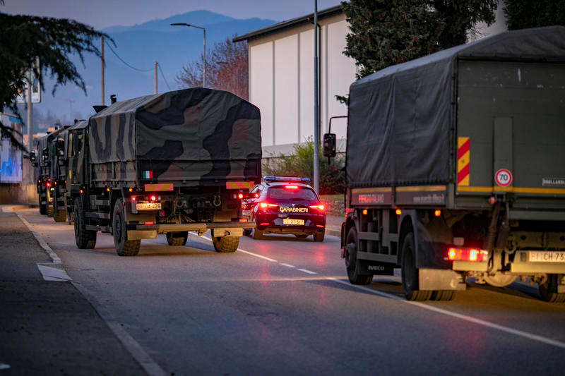 Italian military trucks drive through streets of Bergamo after the army were deployed to move coffins from the town, which is at the centre of the coronavirus disease (COVID-19) outbreak, to neighbouring provinces after funeral services were overwhelmed, in Bergamo, Italy, March 18, 2020. Picture taken March 18, 2020. Sergio Agazzi.Fotogramma via REUTERS ATTENTION EDITORS - ITALY OUT. NO COMMERCIAL OR EDITORIAL SALES IN ITALY AND .IT WEBSITES. THIS IMAGE HAS BEEN SUPPLIED BY A THIRD PARTY. MANDATORY CREDIT.