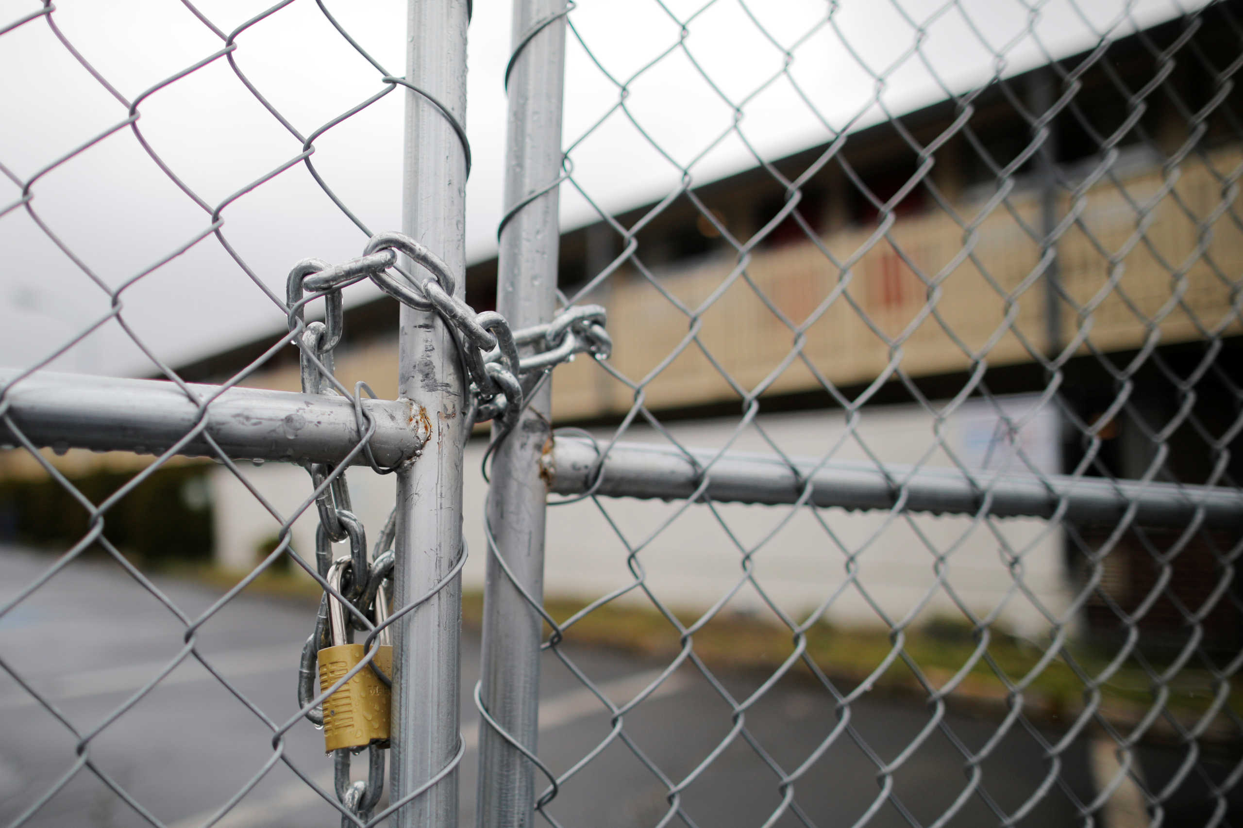 A lock and chain closes the fence around a former motel that was bought by King County as a coronavirus quarantine facility, and reportedly where the first person using the facility left without permission, in Kent, Washington, U.S., March 13, 2020.   REUTERS