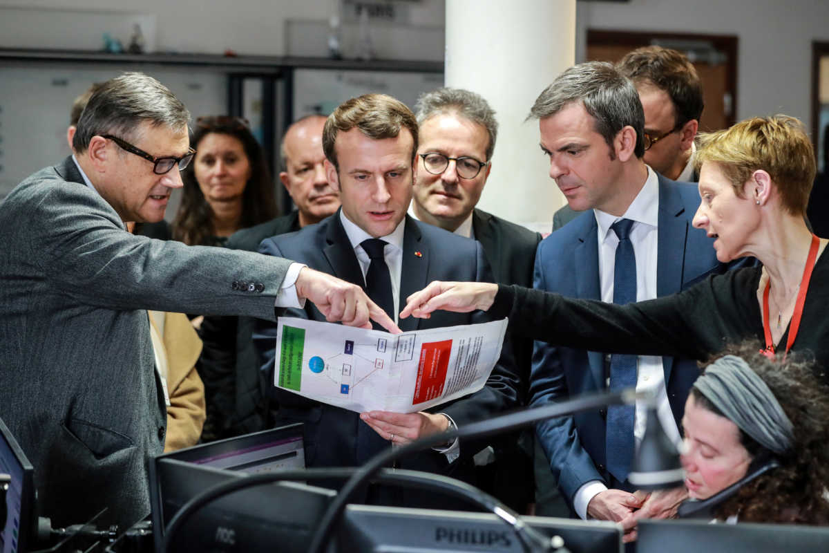 French President Emmanuel Macron, French Health and Solidarity Minister Olivier Veran and AP-HP President Martin Hirsch listen to professor Pierre Carli, director of the Necker hospital SAMU-SMUR emergency services, during a visit at the SAMU-SMUR call centre at the Necker Hospital, focused on COVID-19 coronavirus outbreak, in Paris, France, March 10, 2020. Ludovic Marin